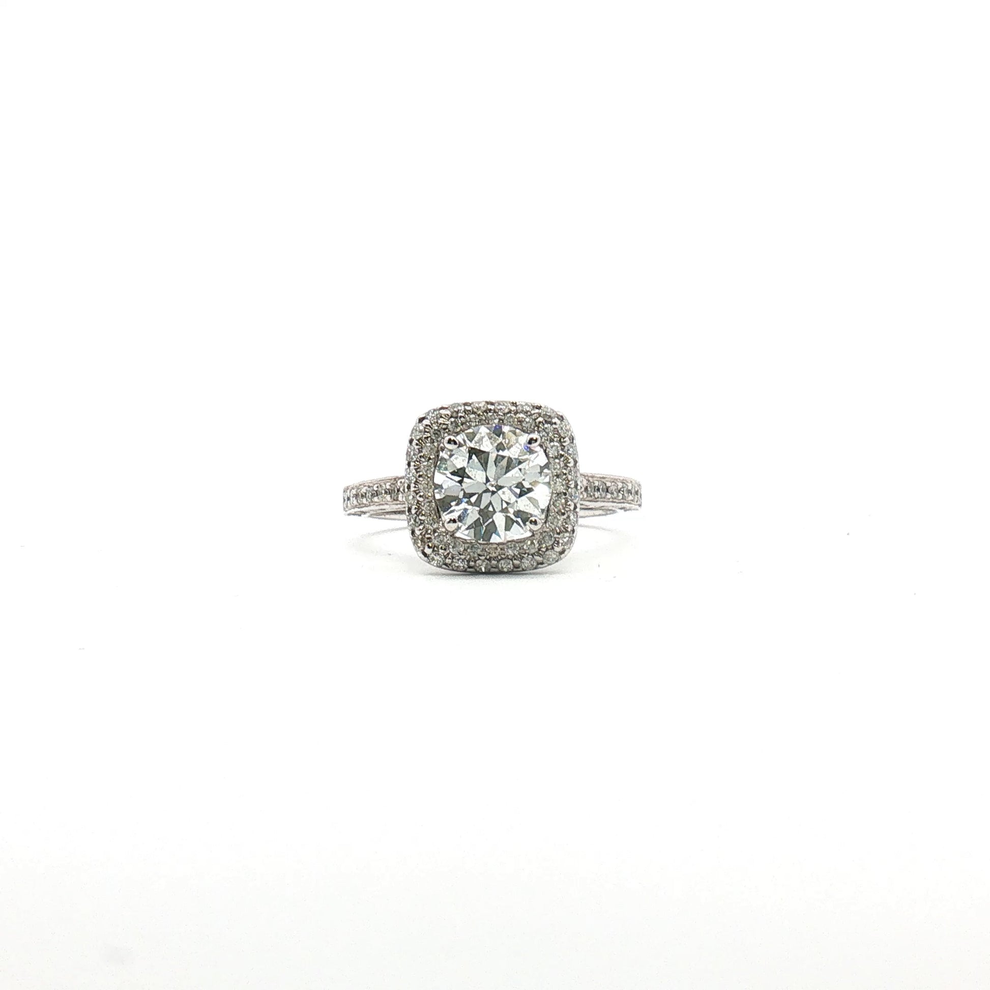 14K white gold diamond halo ring with a central gemstone and smaller accent diamonds, showcasing elegant jewelry design.