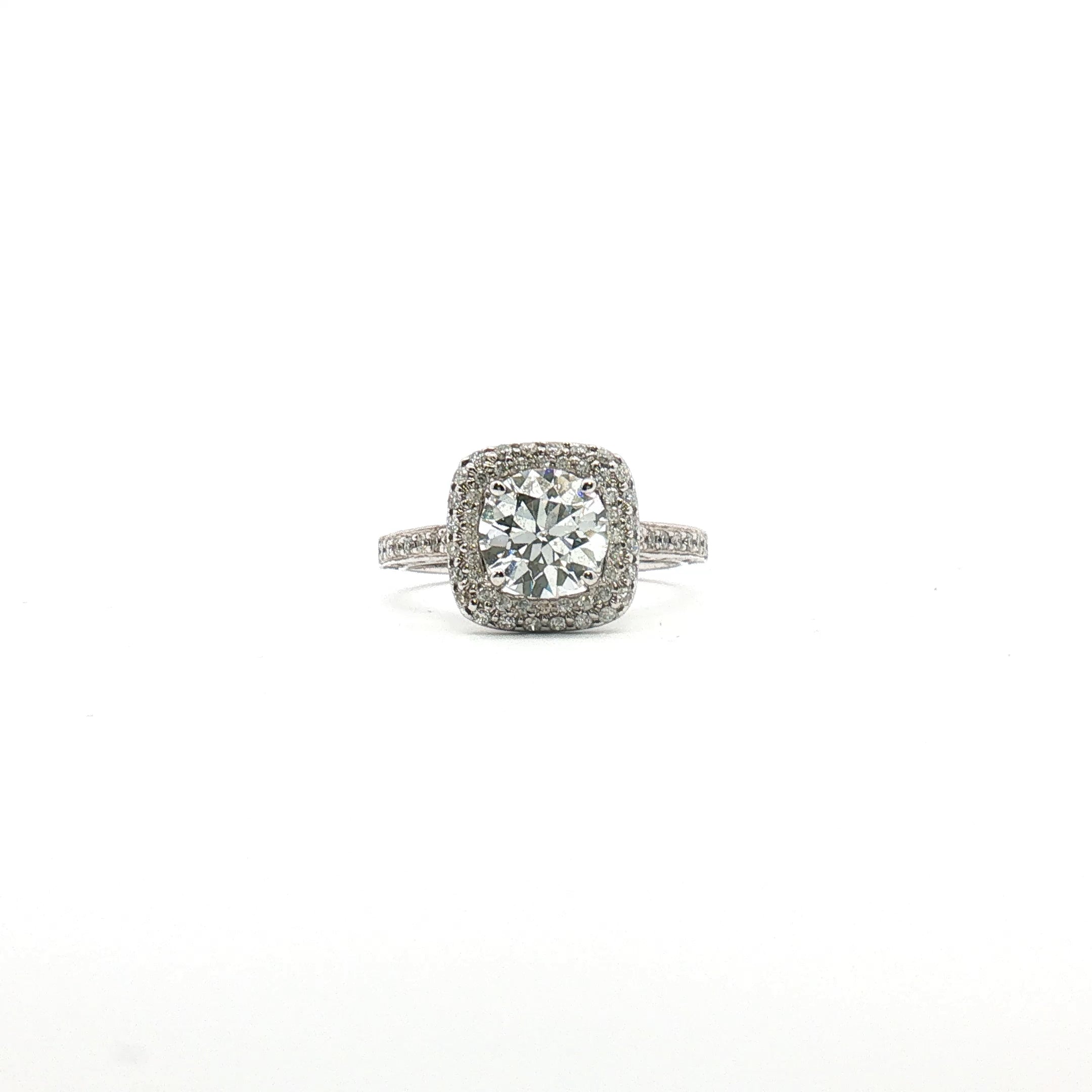 14K white gold diamond halo ring with a central gemstone and smaller accent diamonds, showcasing elegant jewelry design.
