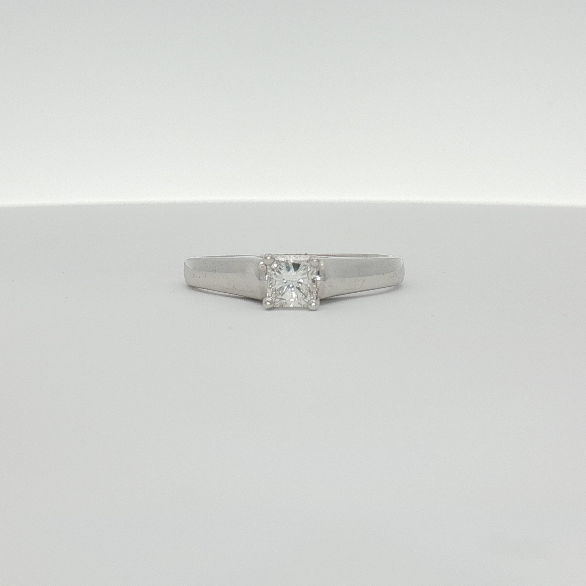 18K white gold diamond solitaire engagement ring with a sparkling center stone, crafted by Gold & Beyond.