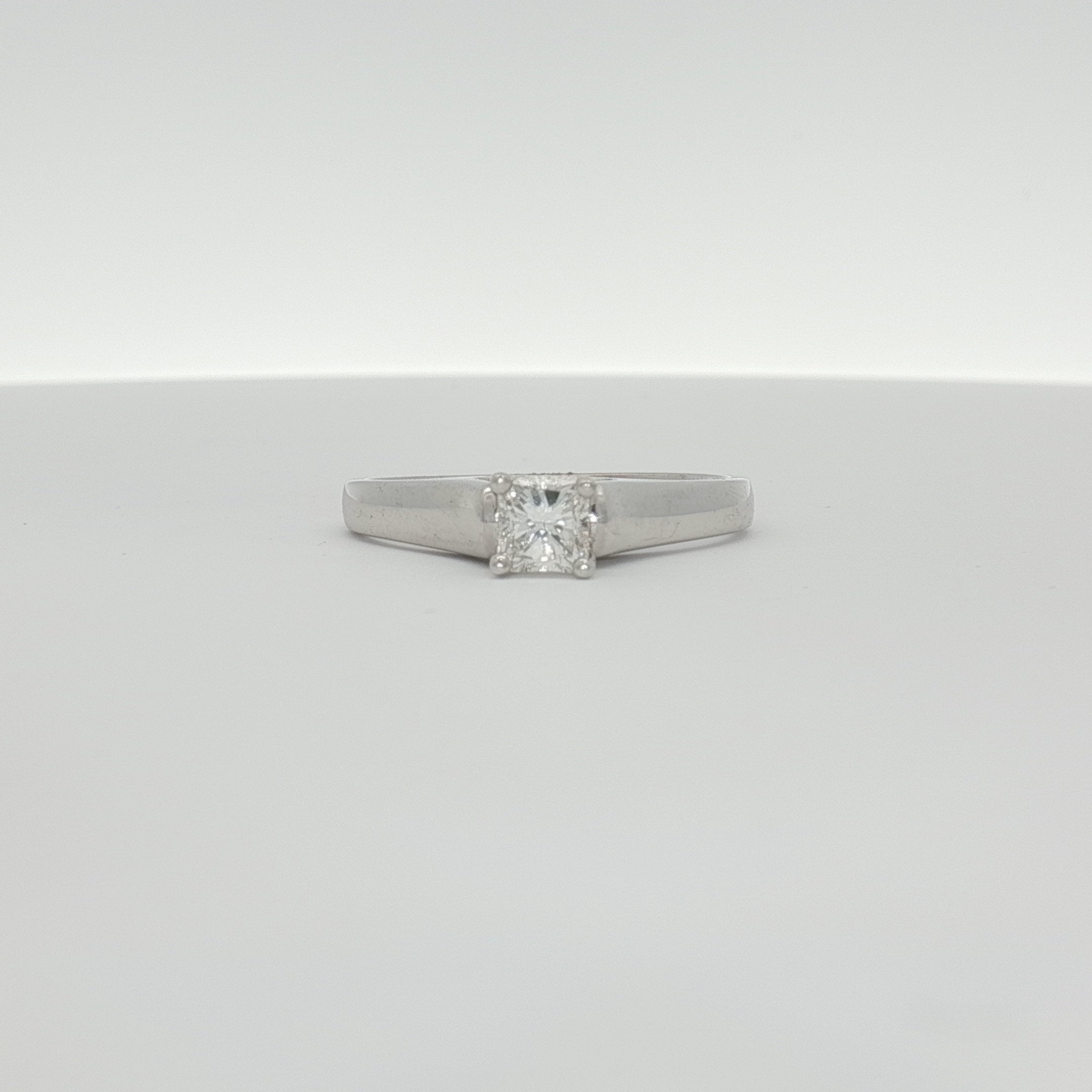 Elegant 18K white gold diamond solitaire engagement ring with a central sparkling diamond and sleek band, crafted by Gold & Beyond.