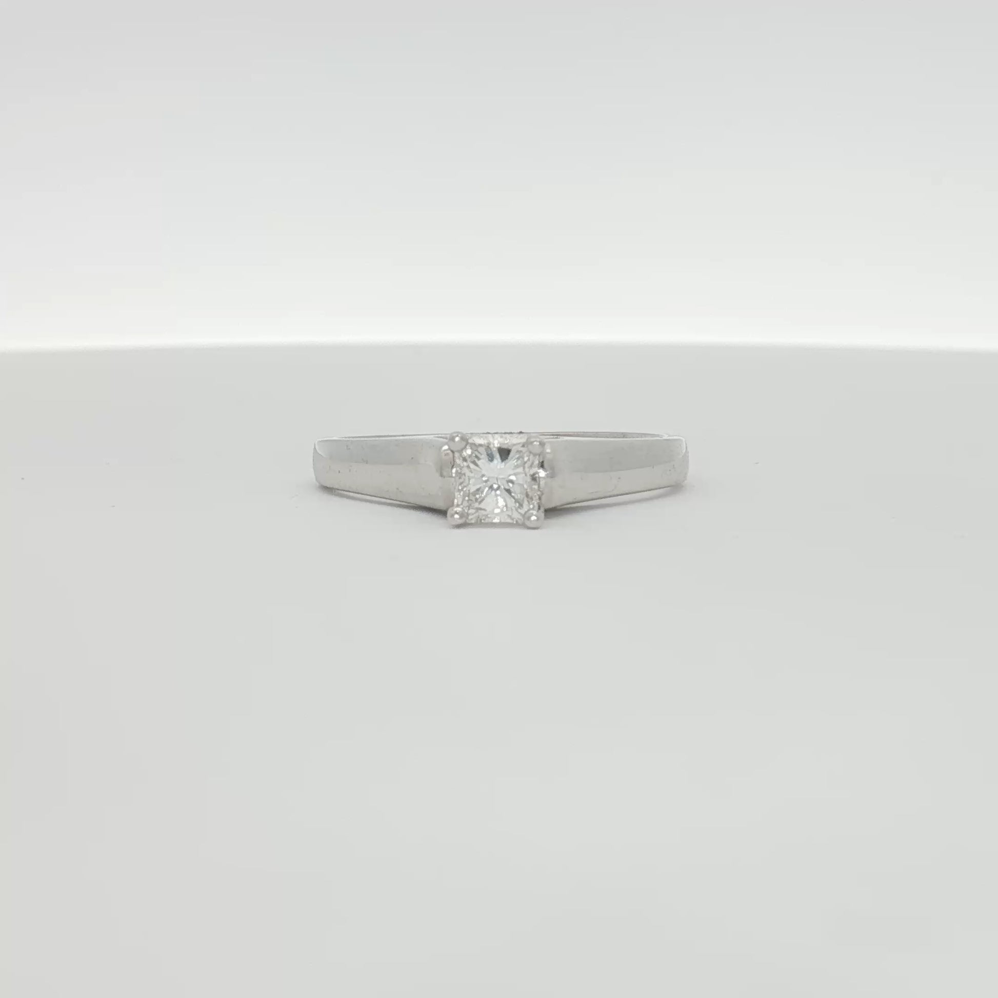 18K white gold diamond solitaire engagement ring with a central sparkling diamond and elegant band from Gold & Beyond.