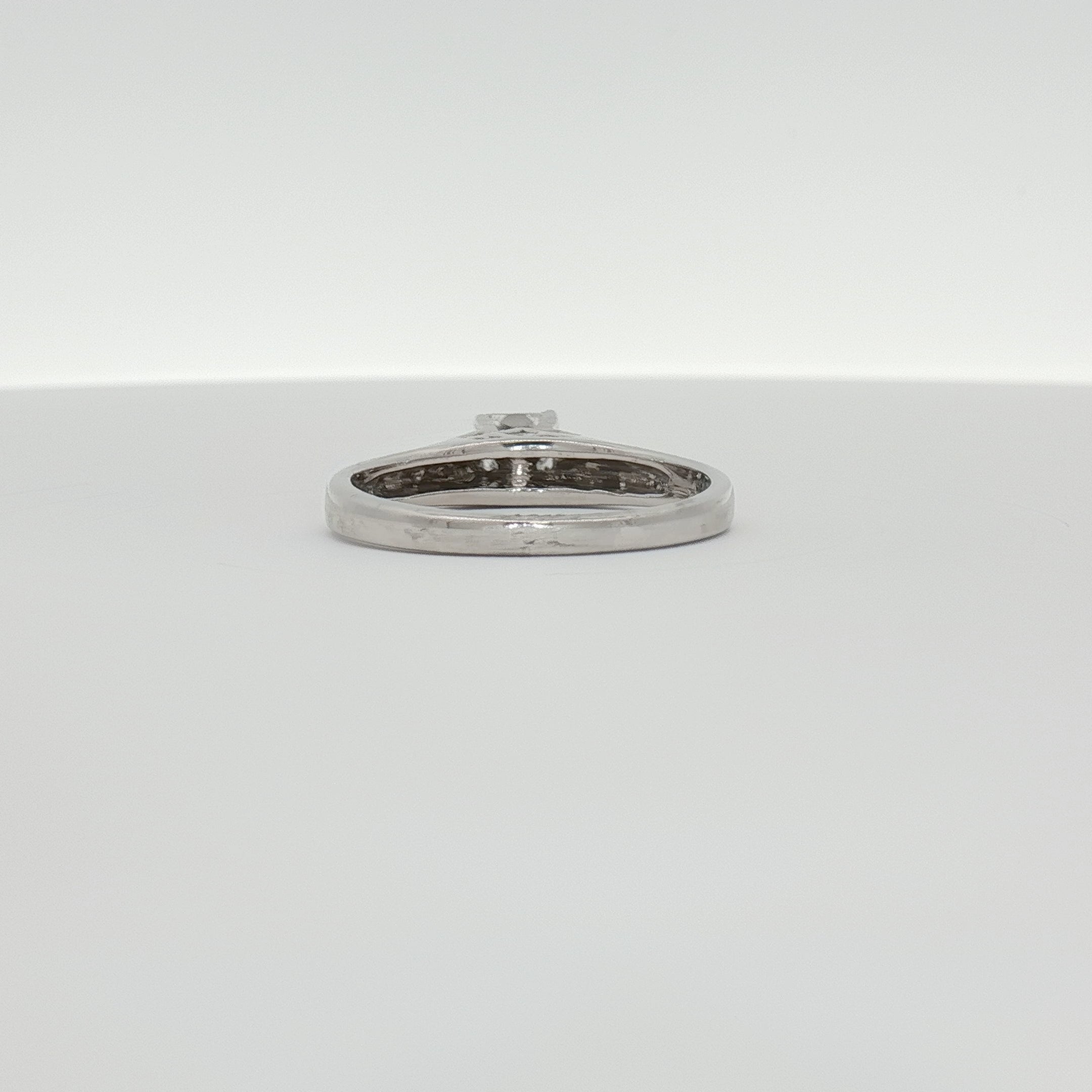 18K white gold diamond solitaire engagement ring featuring a sparkling center stone, crafted by Gold & Beyond.