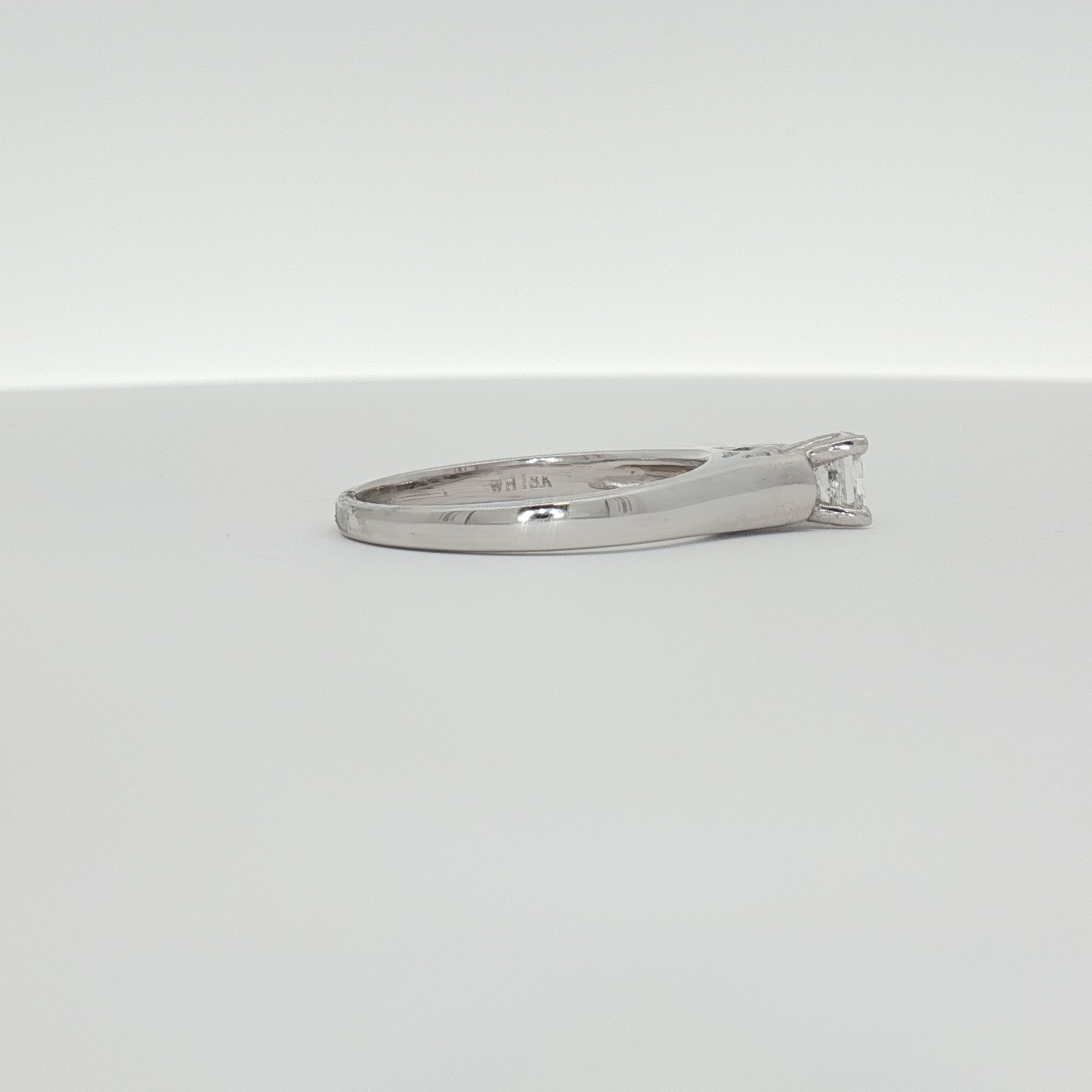 18K white gold diamond solitaire engagement ring featuring a sparkling central diamond and elegant band design.