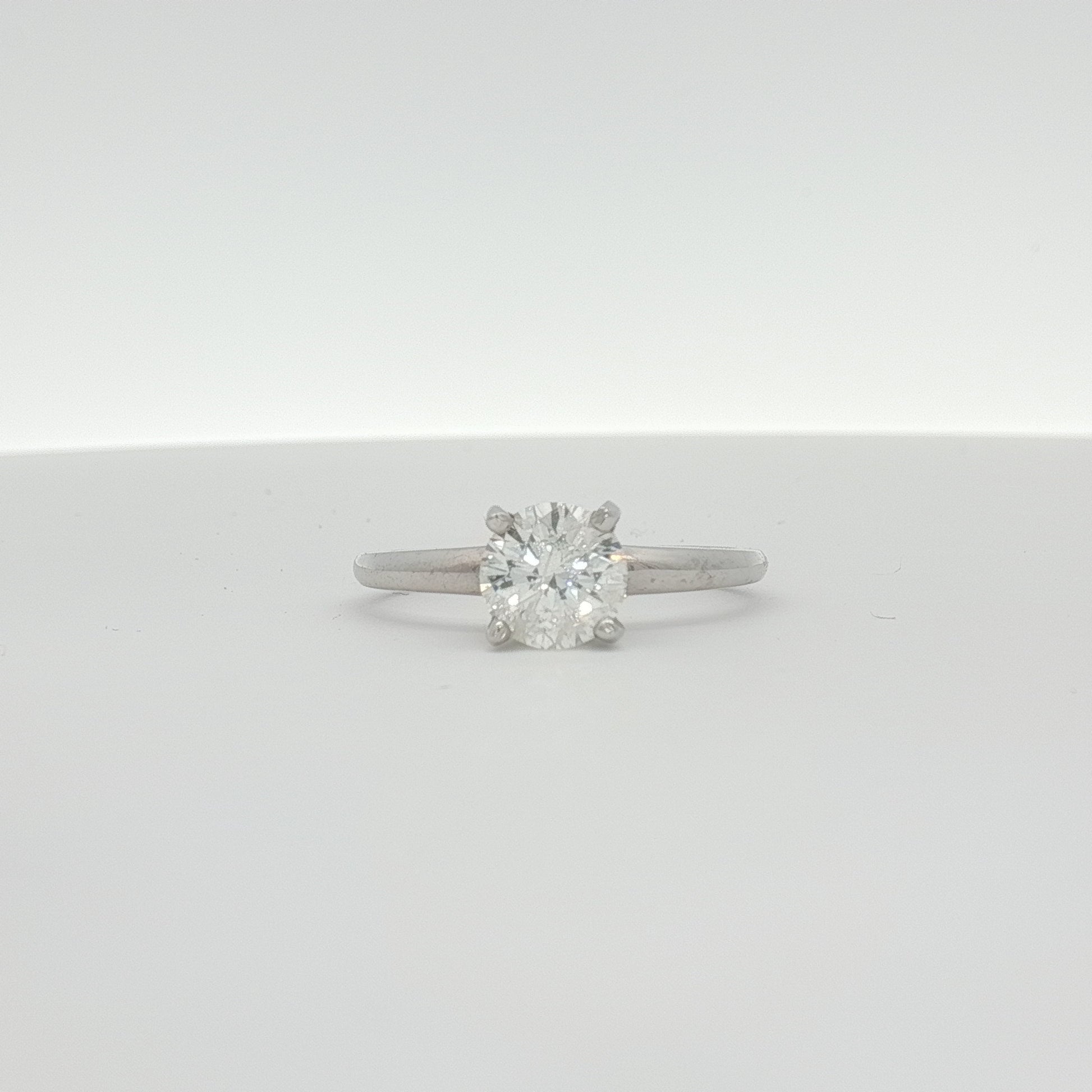 14K white gold diamond engagement ring with a sparkling central diamond and elegant band from Gold & Beyond.