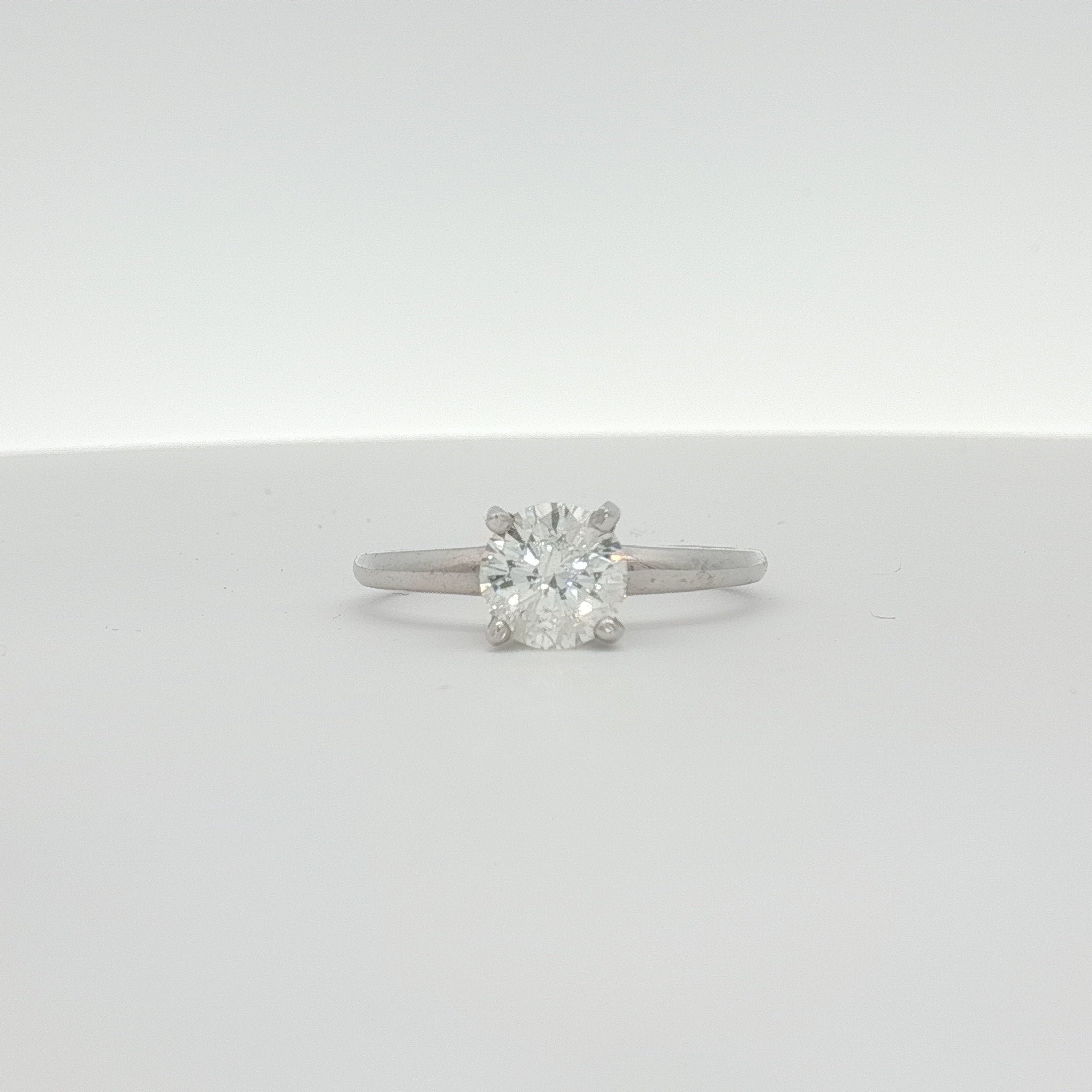 14K white gold diamond engagement ring with a sparkling central diamond and elegant band from Gold & Beyond.