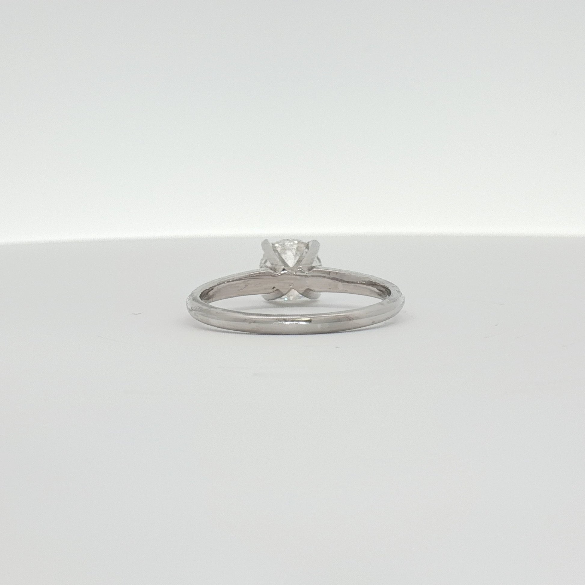14K white gold diamond engagement ring with a central sparkling diamond and intricate band design, from Gold & Beyond Jewelry.