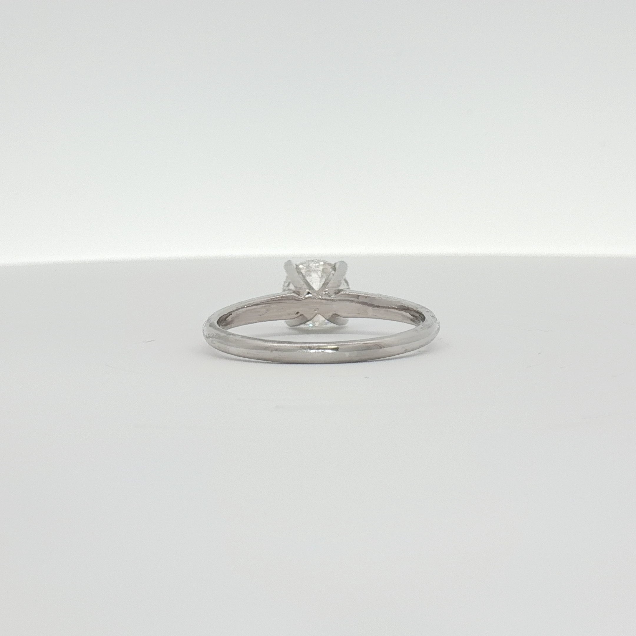 14K white gold diamond engagement ring with a central sparkling diamond and intricate band design, from Gold & Beyond Jewelry.