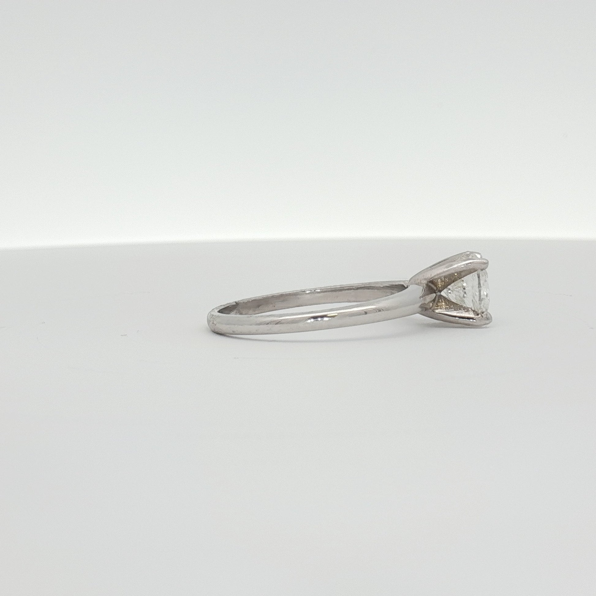 14K white gold diamond engagement ring with a central sparkling diamond and elegant band, from Gold & Beyond jewelry collection.