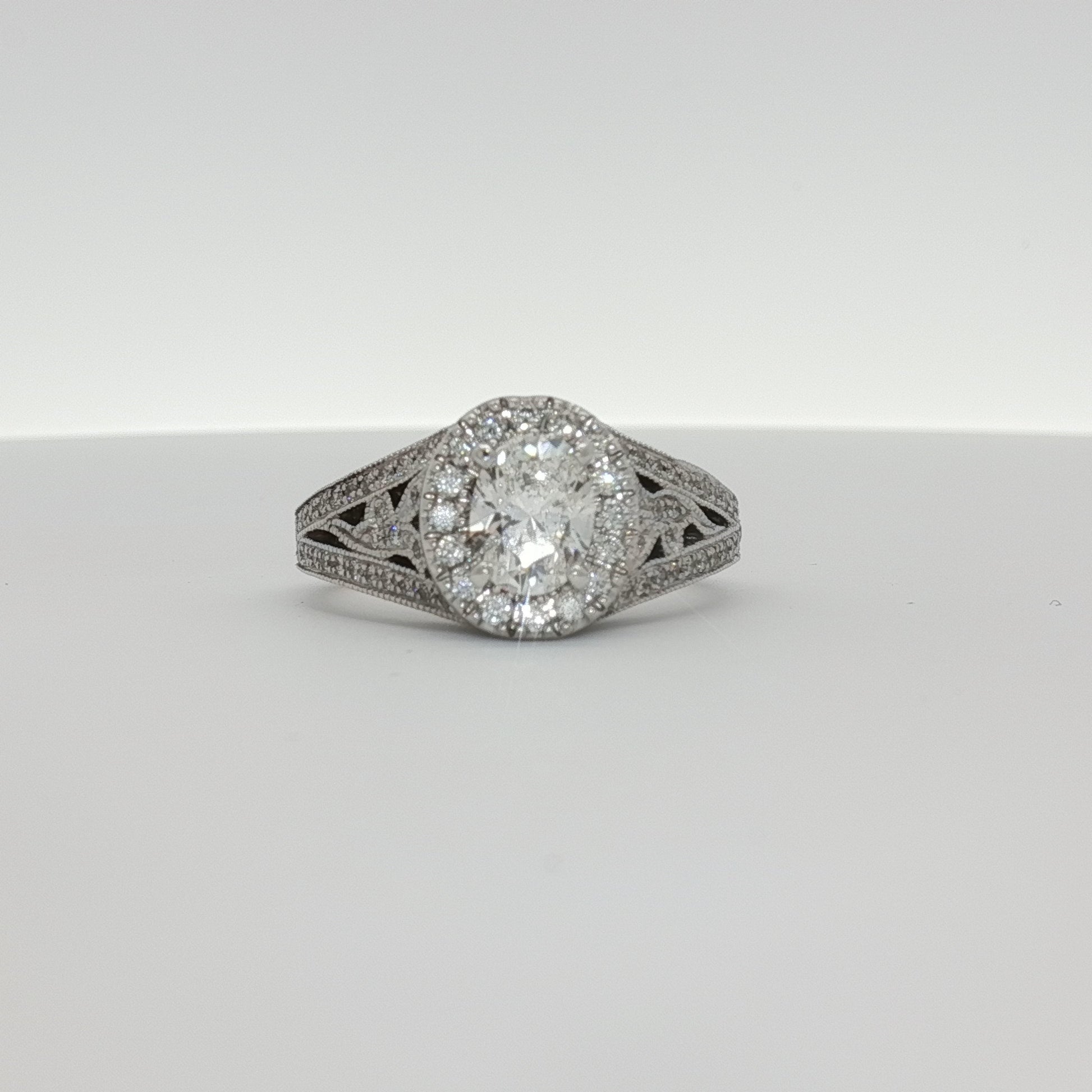 14K white gold diamond engagement ring with a central sparkling diamond and elegant band, crafted by Gold & Beyond.