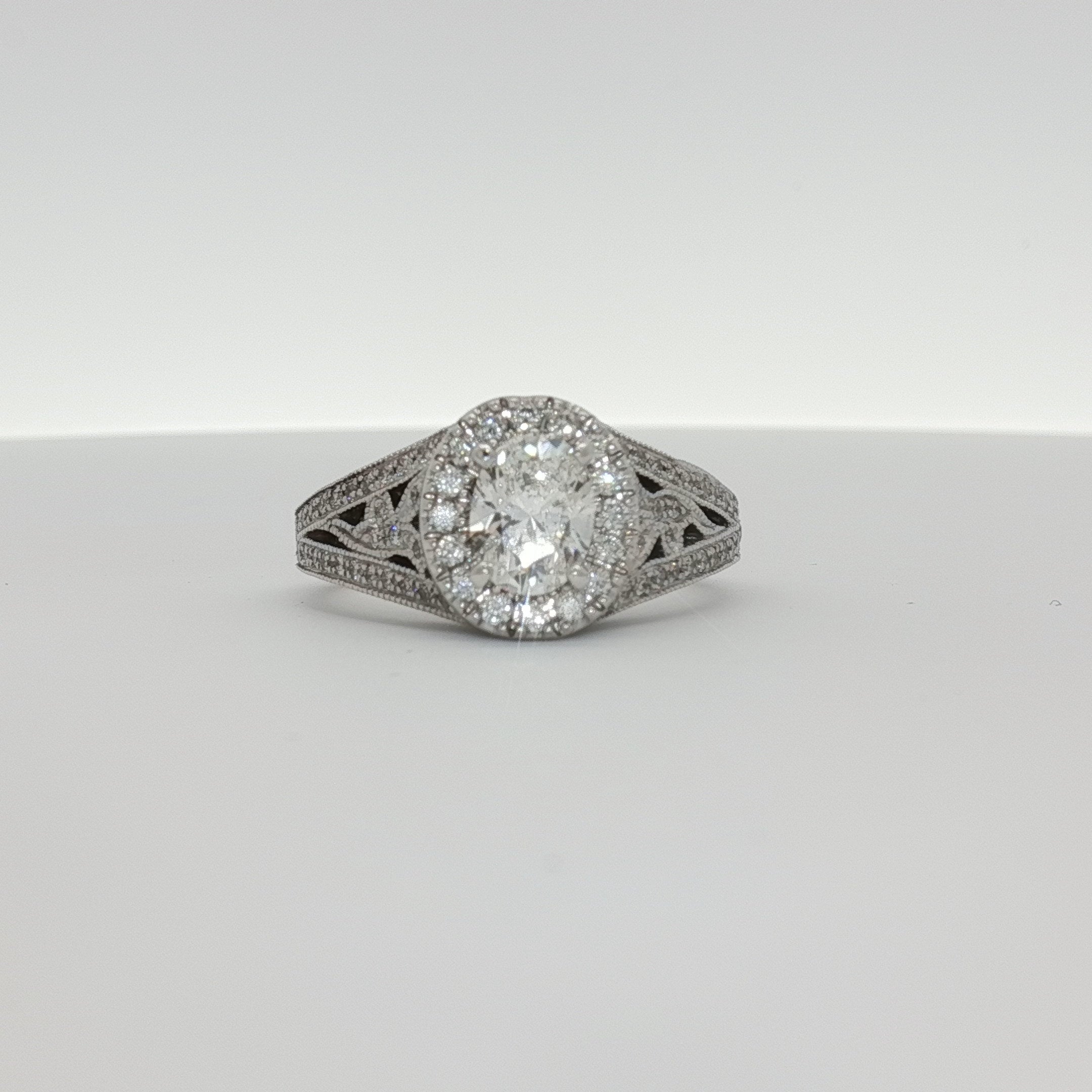 14K white gold diamond engagement ring with a central sparkling diamond and elegant band, crafted by Gold & Beyond.