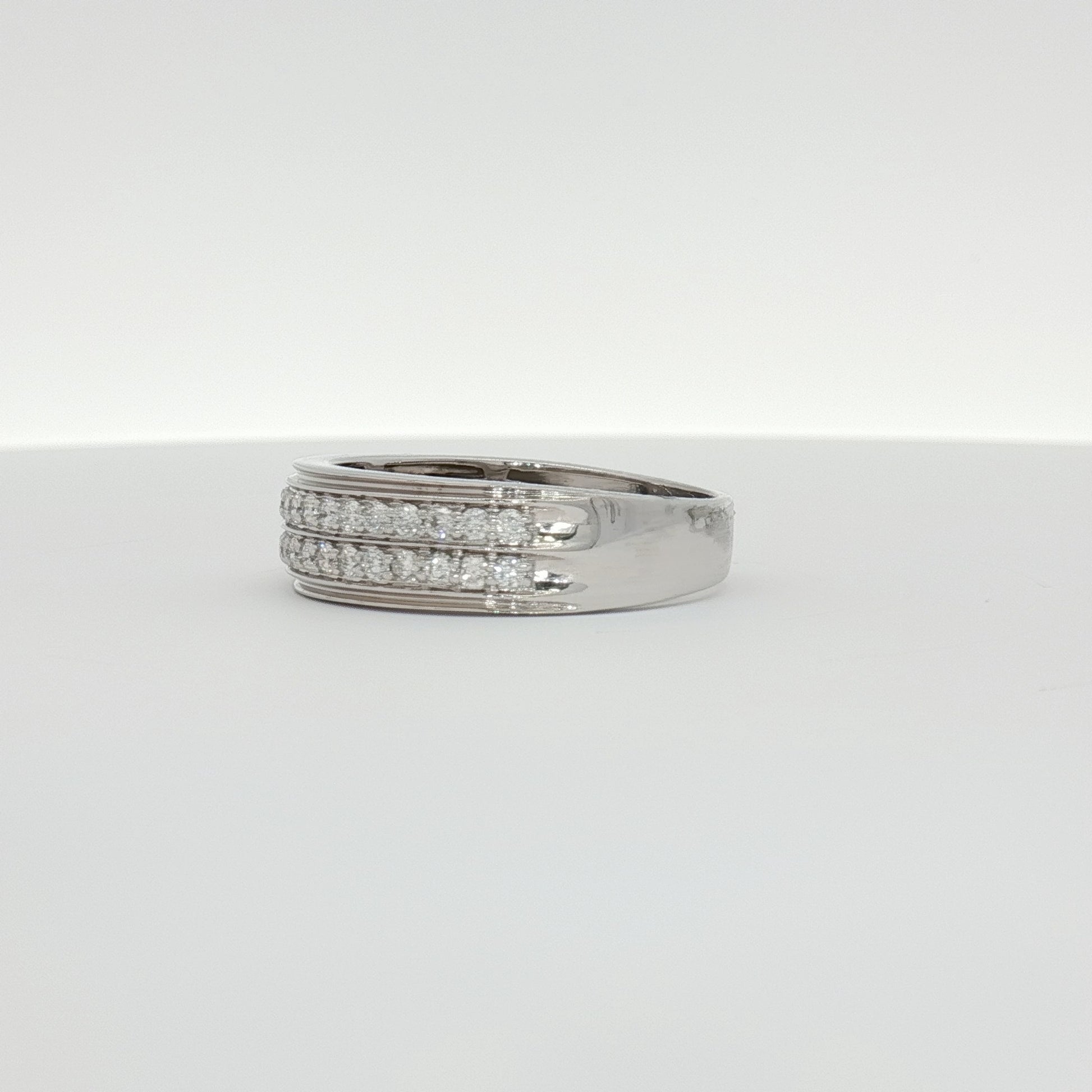 14K white gold diamond men's band ring with sparkling diamonds, crafted by Gold & Beyond, showcasing elegant jewelry design.