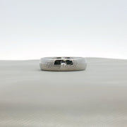 Platinum wedding band ring from Tiffany & Co. featuring a sleek, polished jewelry design with subtle branding details.