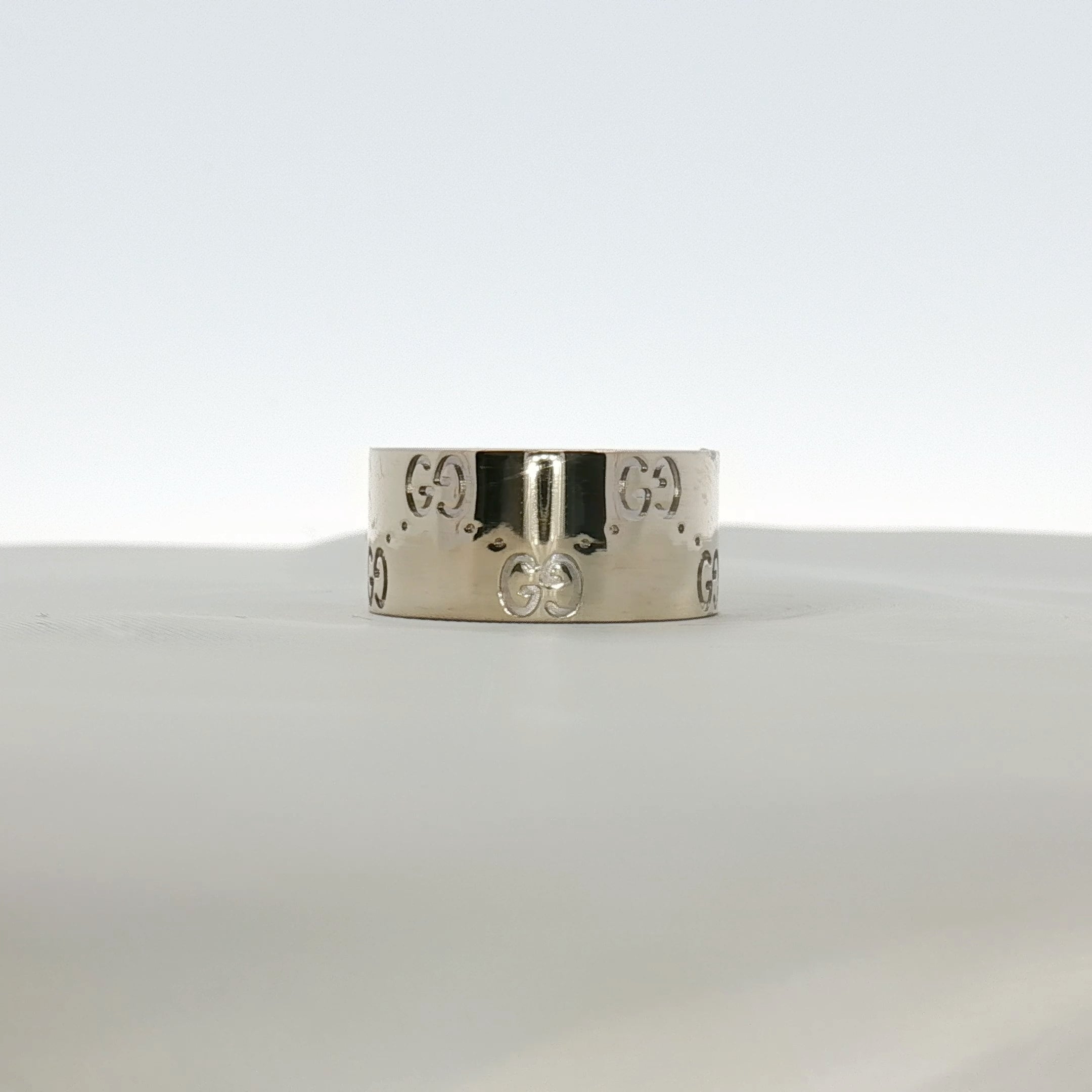 Gold & Beyond Gucci Interlocking G wide band jewelry ring with a bold, engraved interlocking G design on polished gold metal.