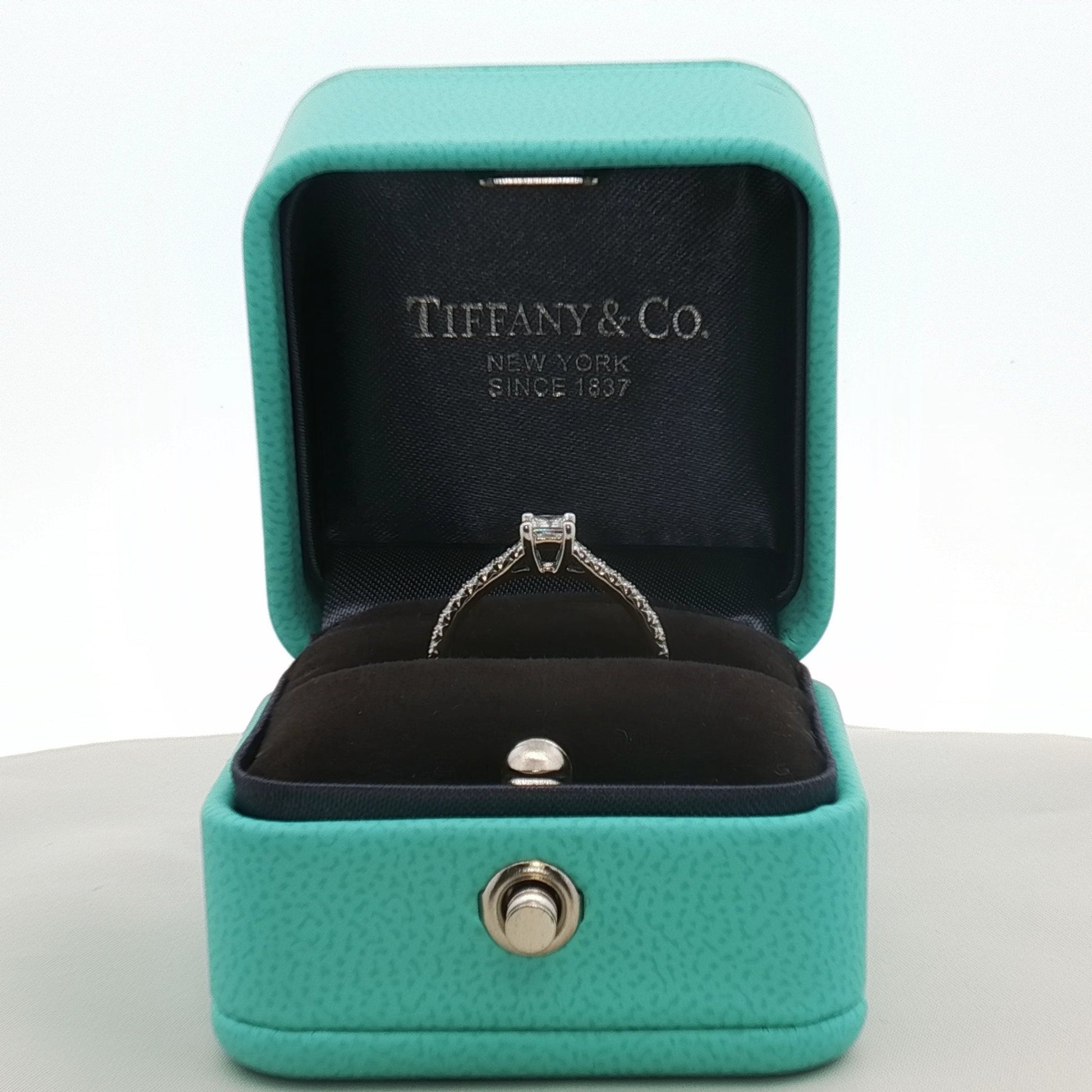 Gold & Beyond Tiffany & Co. pavé diamond solitaire engagement ring showcasing a sparkling central diamond and intricate detailing.