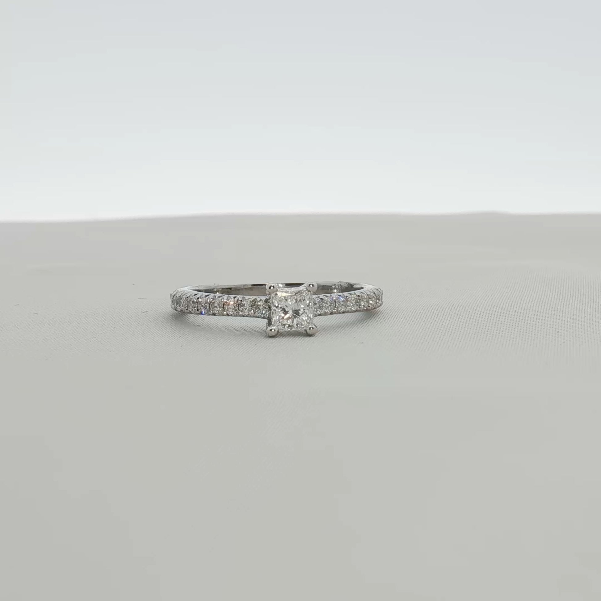 Gold & Beyond Tiffany & Co. pavé diamond solitaire engagement ring with a sleek band and sparkling central diamond.