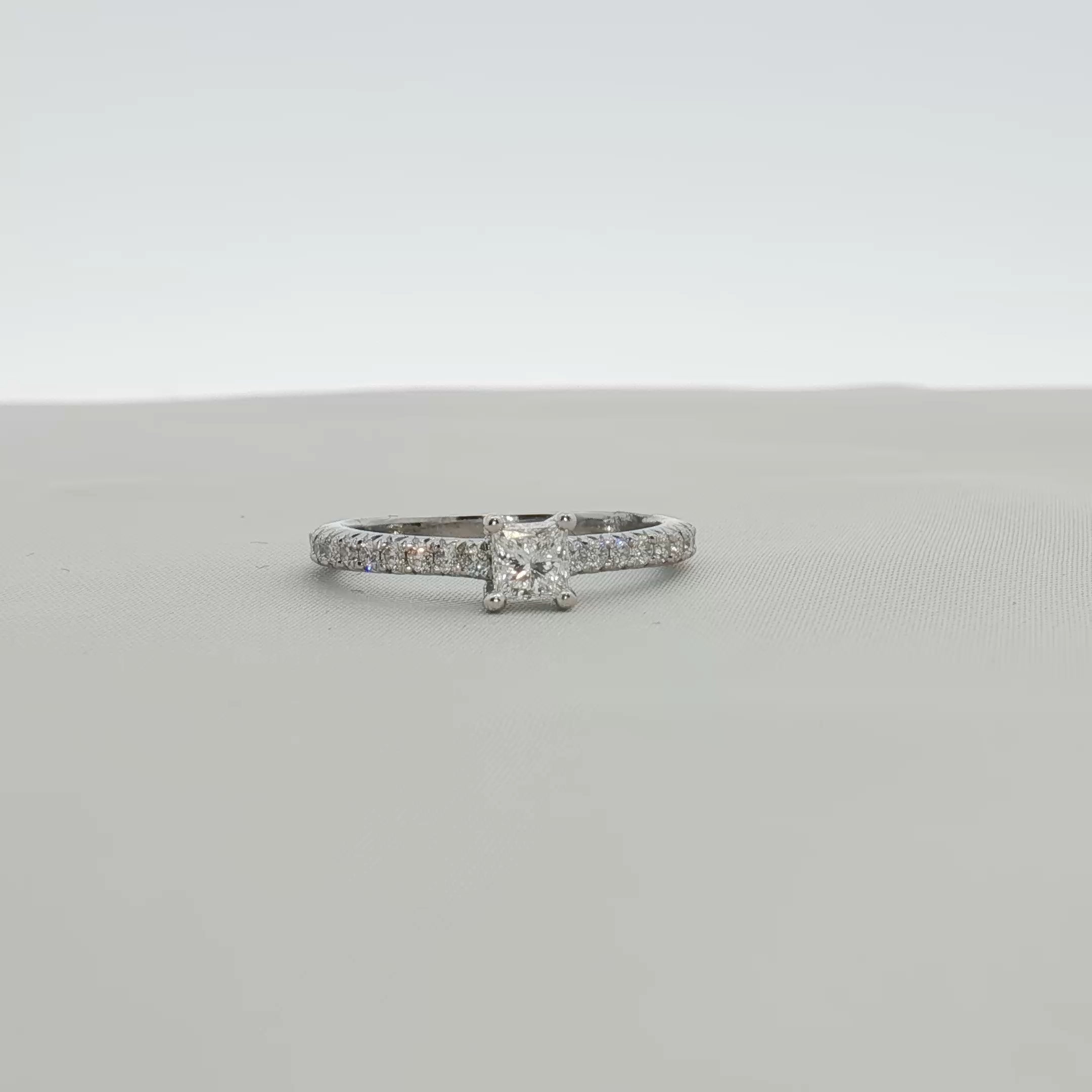 Gold & Beyond Tiffany & Co. pavé diamond solitaire engagement ring with a sleek band and sparkling central diamond.