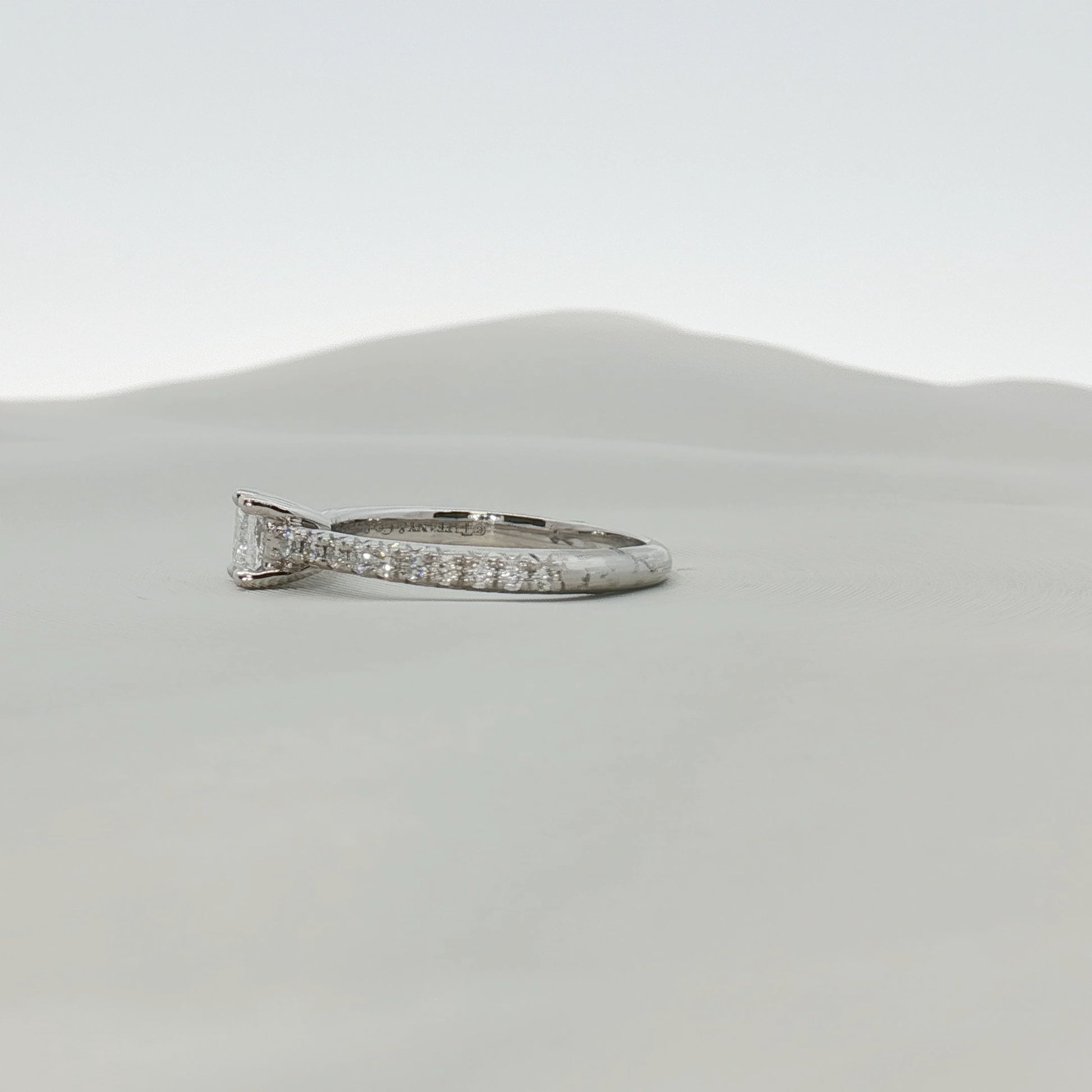 Gold & Beyond Tiffany & Co. pavé diamond solitaire engagement ring featuring a central diamond and intricate pave setting.