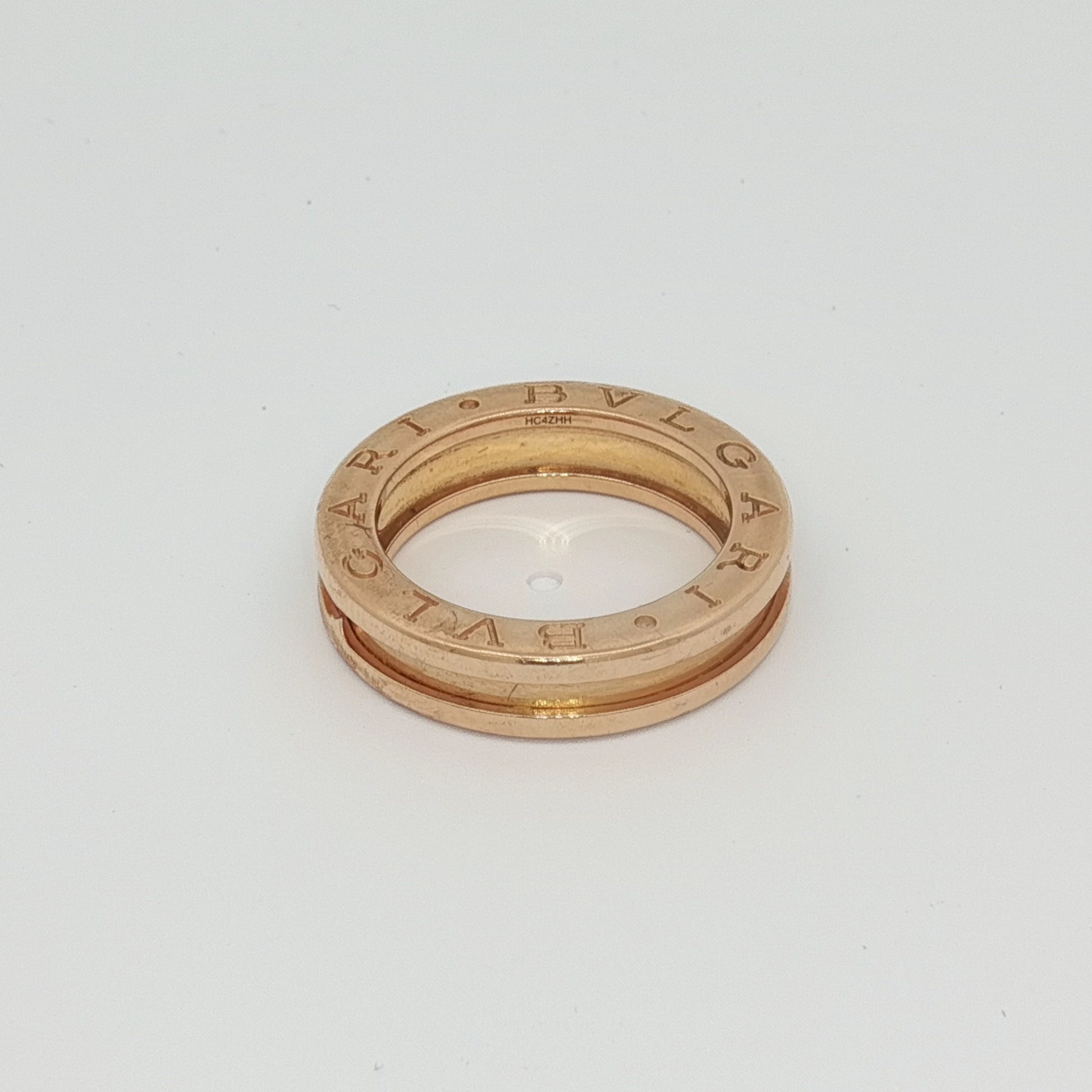 Bulgari B.Zero1 ring in gold jewelry with smooth, rounded band and signature design, displayed on a neutral background.