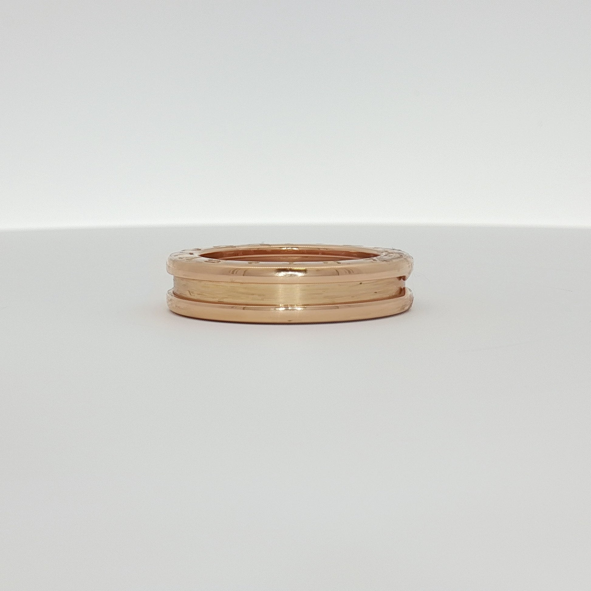 Gold & Beyond Bulgari B.Zero1 ring, a sleek gold jewelry piece with distinctive design and smooth finish, displayed on a neutral background.
