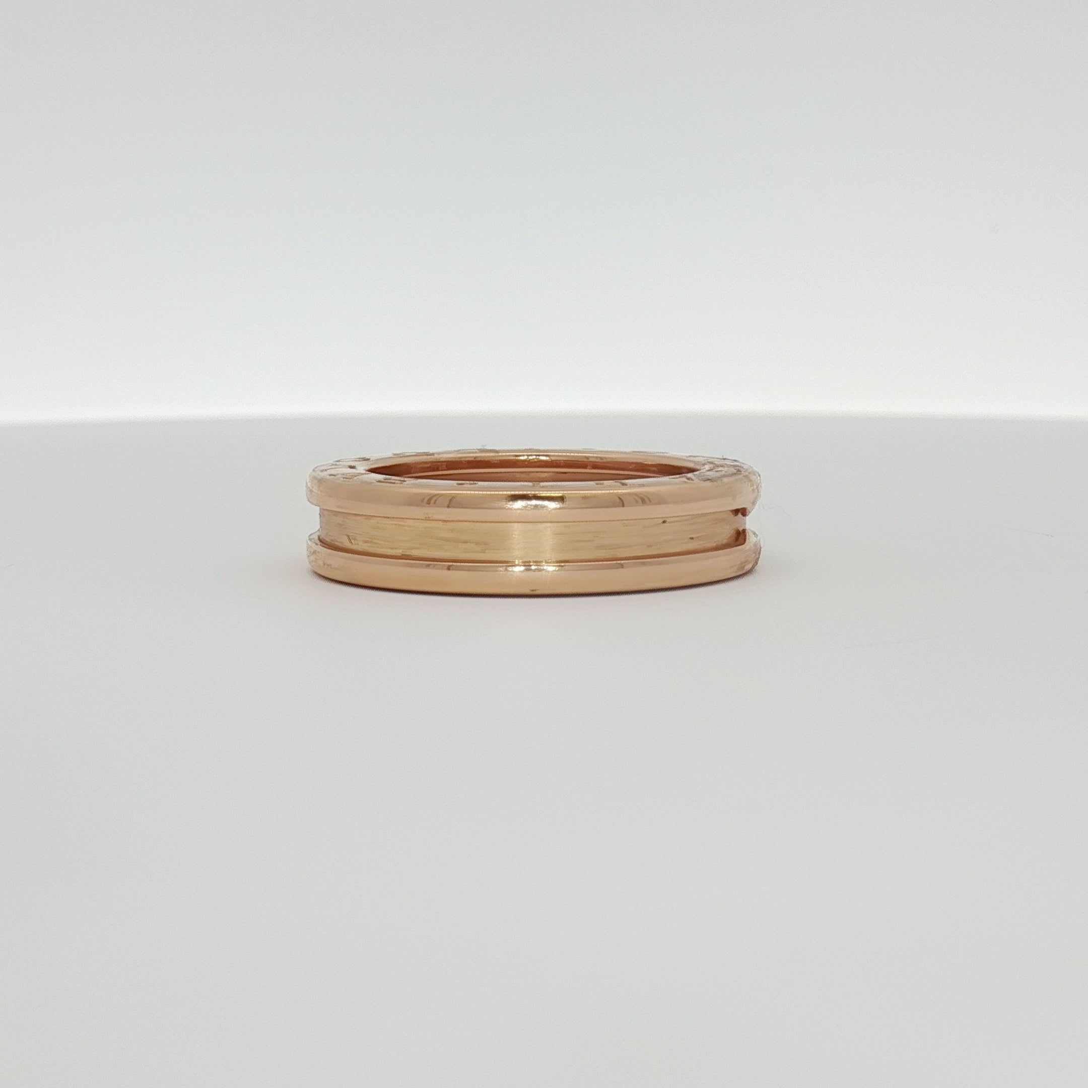 Gold & Beyond Bulgari B.Zero1 ring, a sleek gold jewelry piece with distinctive design and smooth finish, displayed on a neutral background.