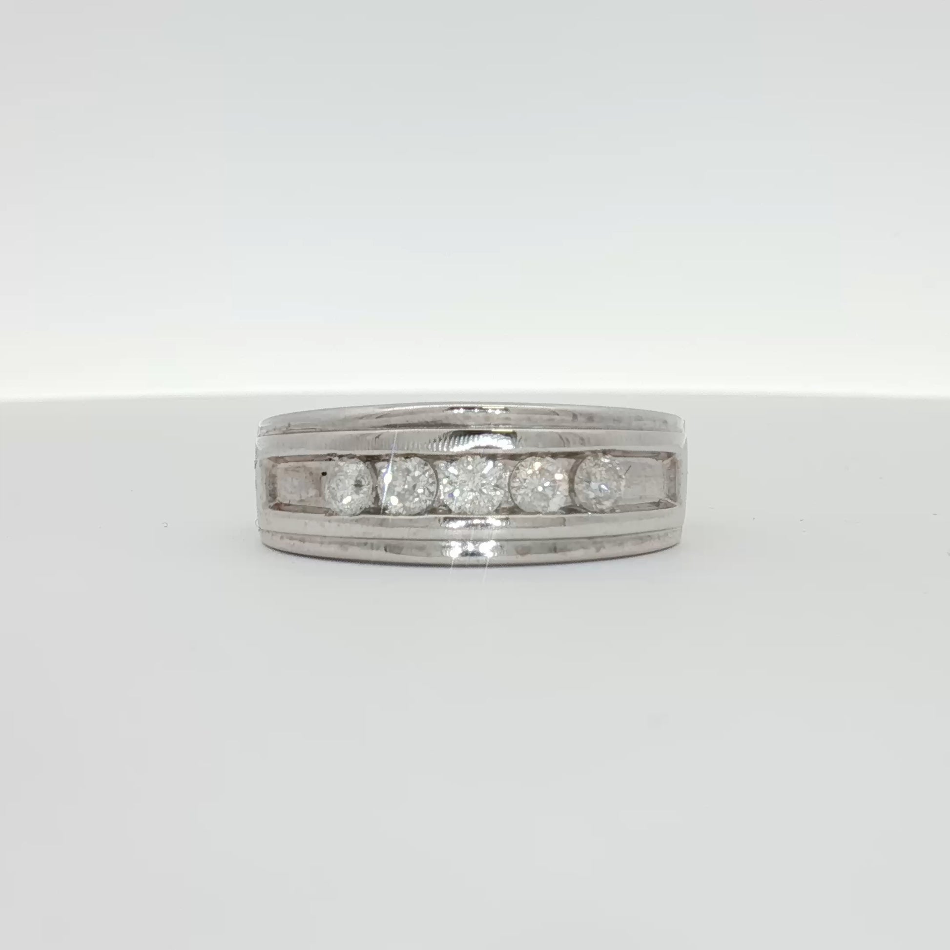 Men's 10K white gold diamond wedding band from Gold & Beyond with a sleek, polished finish and embedded diamonds for elegant style.