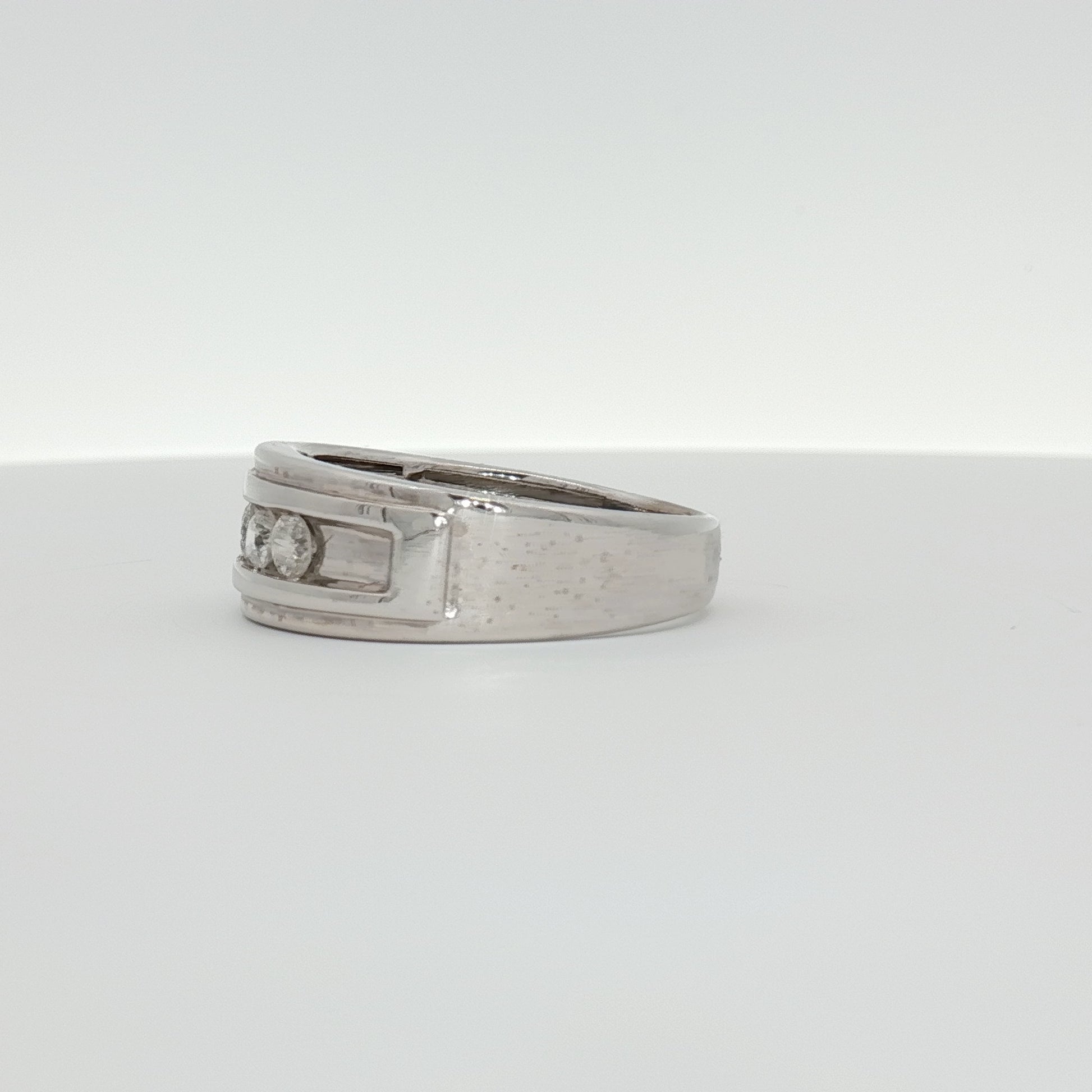Men's 10K white gold wedding band with diamond accents, jewelry by Gold & Beyond, showcasing the sleek and polished design.