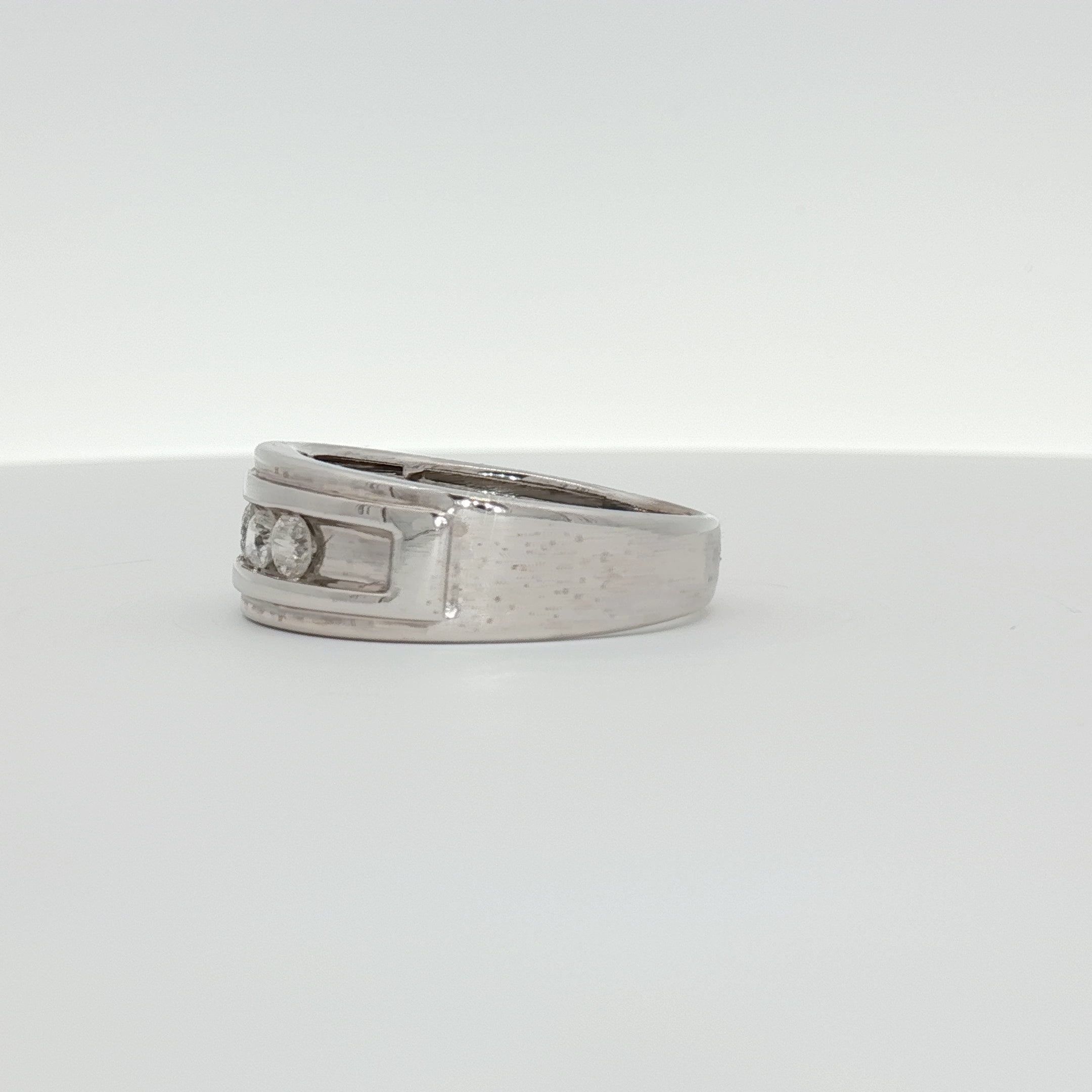 Men's 10K white gold wedding band with diamond accents, jewelry by Gold & Beyond, showcasing the sleek and polished design.