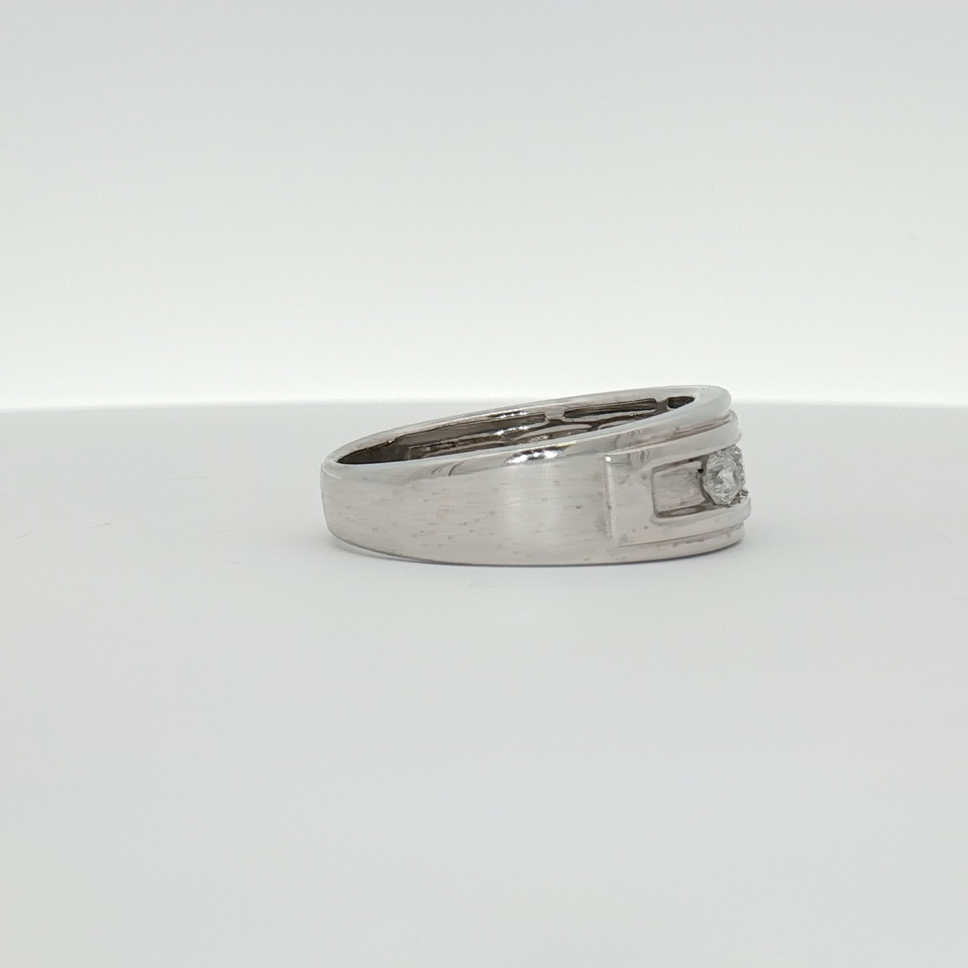 10K white gold diamond men's wedding band by Gold & Beyond with sparkling diamonds and polished finish.