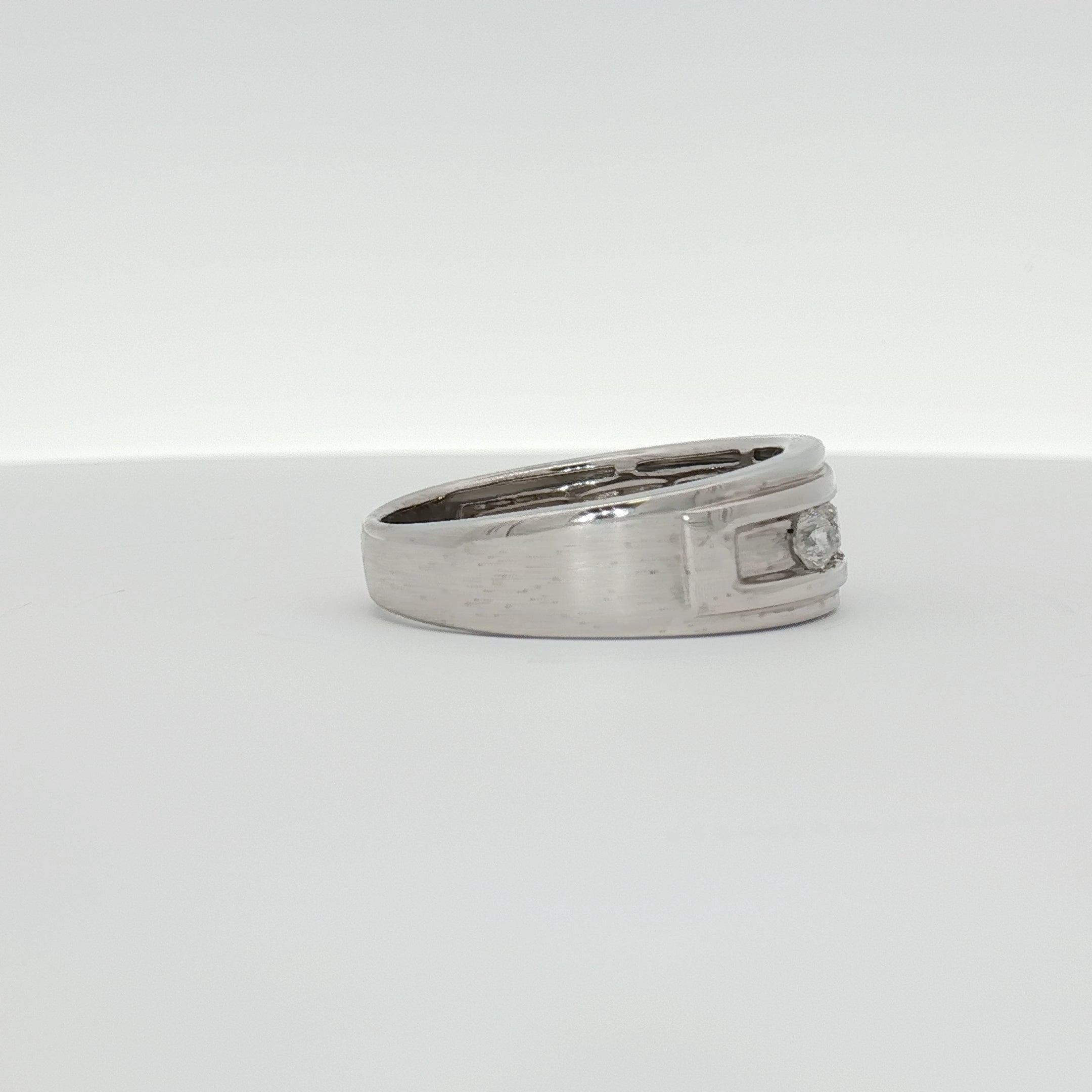 10K white gold diamond men's wedding band by Gold & Beyond with sparkling diamonds and polished finish.