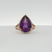 14K yellow gold amethyst and diamond halo ring with intricate gemstone setting, showcasing elegant jewelry craftsmanship.