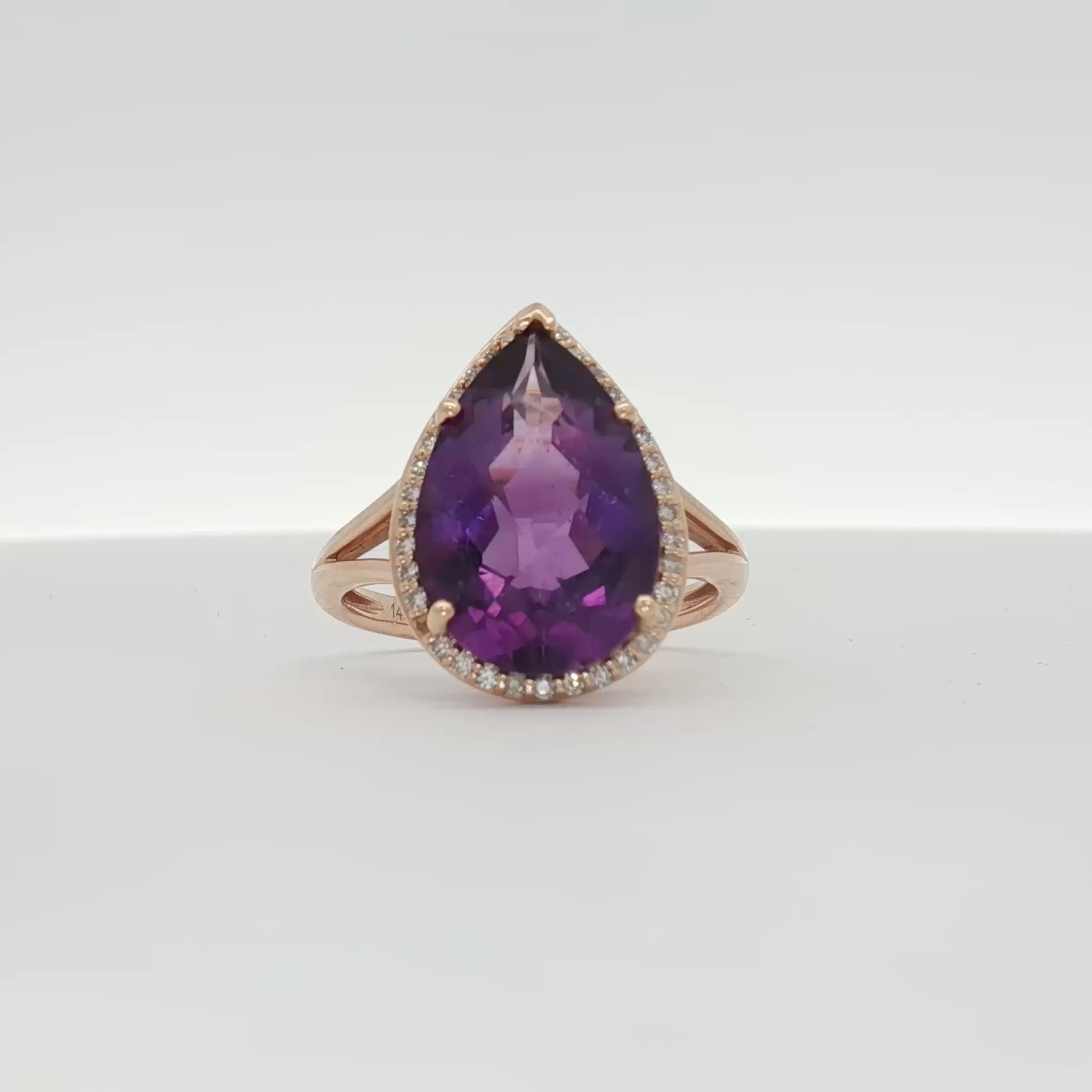 14K yellow gold amethyst and diamond halo ring showcasing a central purple gemstone surrounded by sparkling diamonds.