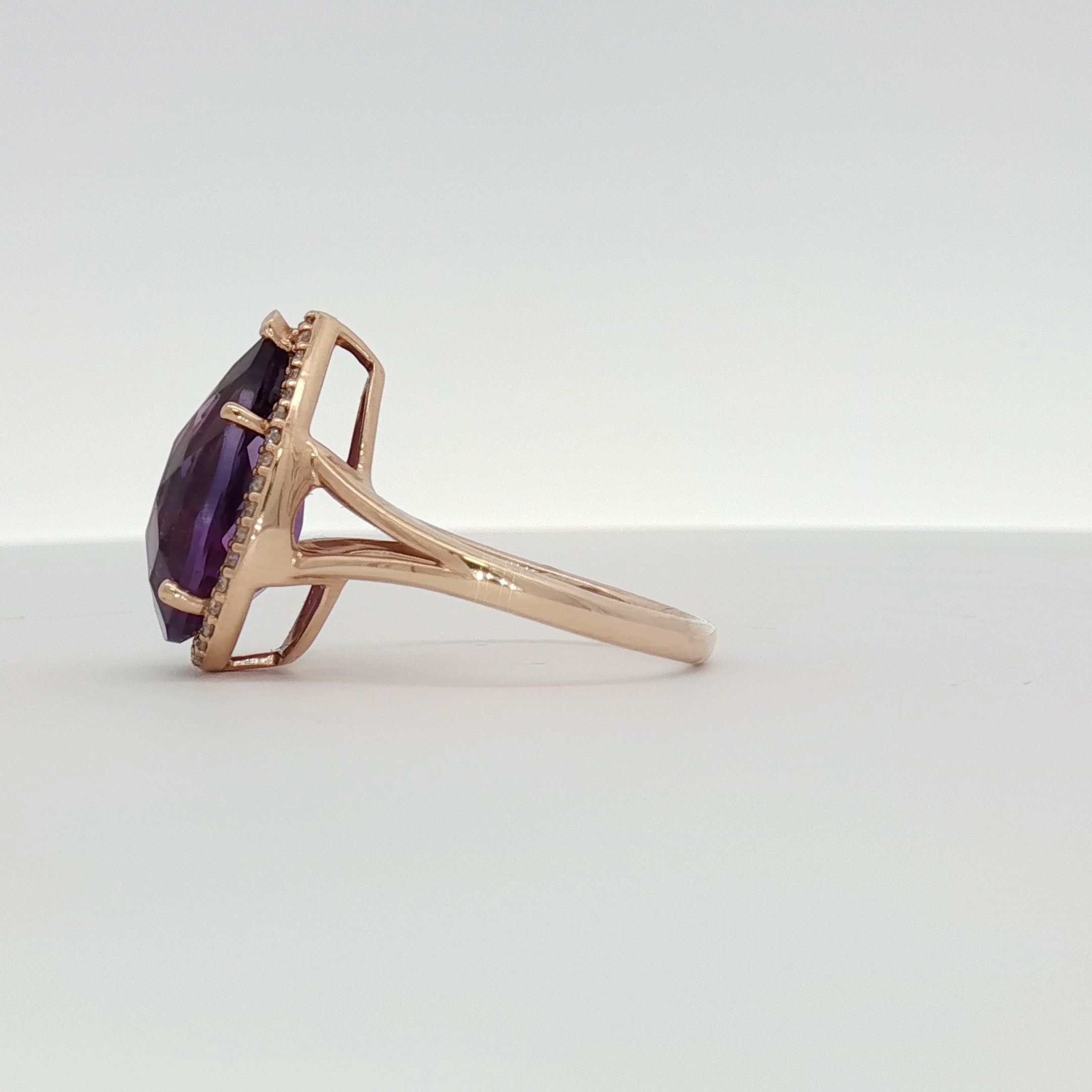 14K yellow gold amethyst and diamond halo ring featuring a central purple gemstone and sparkling accents, jewelry by Gold & Beyond