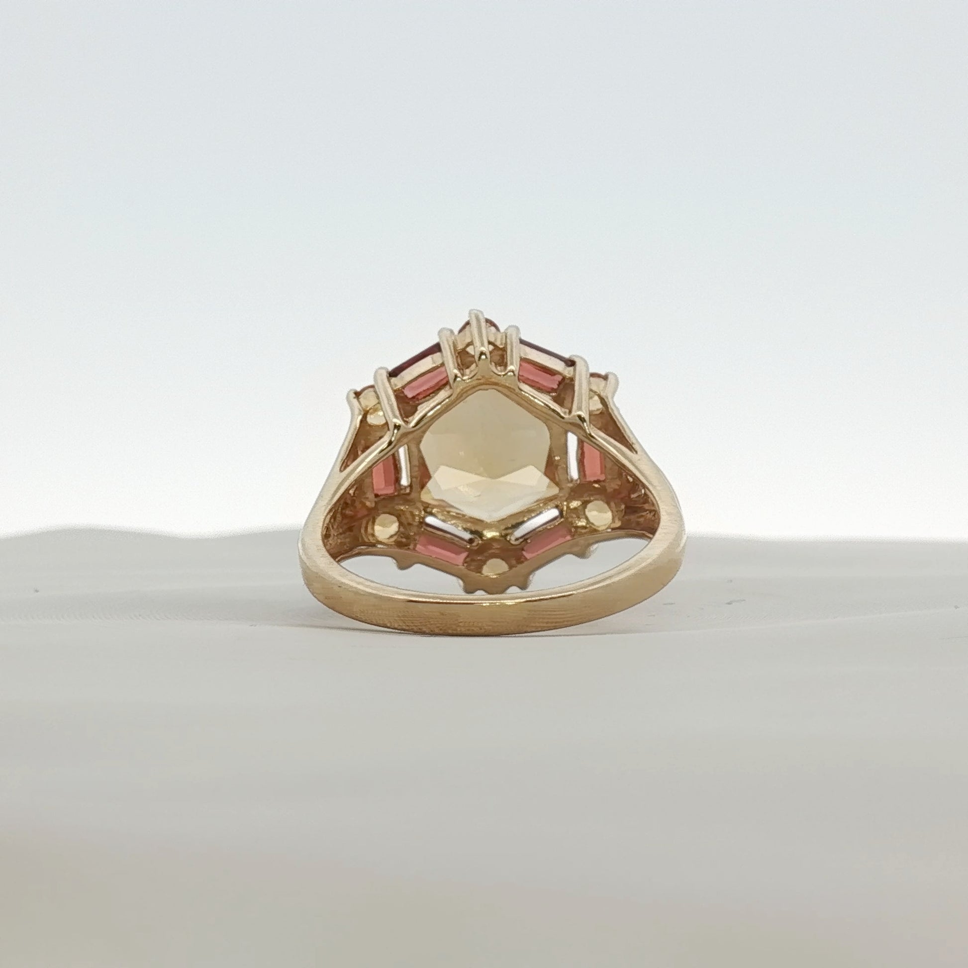 Yellow gold citrine and accent stone ring from Gold & Beyond, showcasing a sparkling gemstone set in a polished jewelry design.