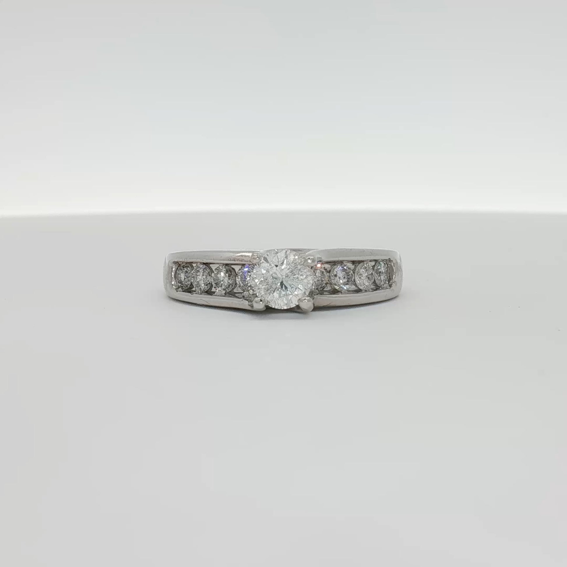 Platinum diamond ring by Gold & Beyond featuring a sparkling central diamond on a sleek band.