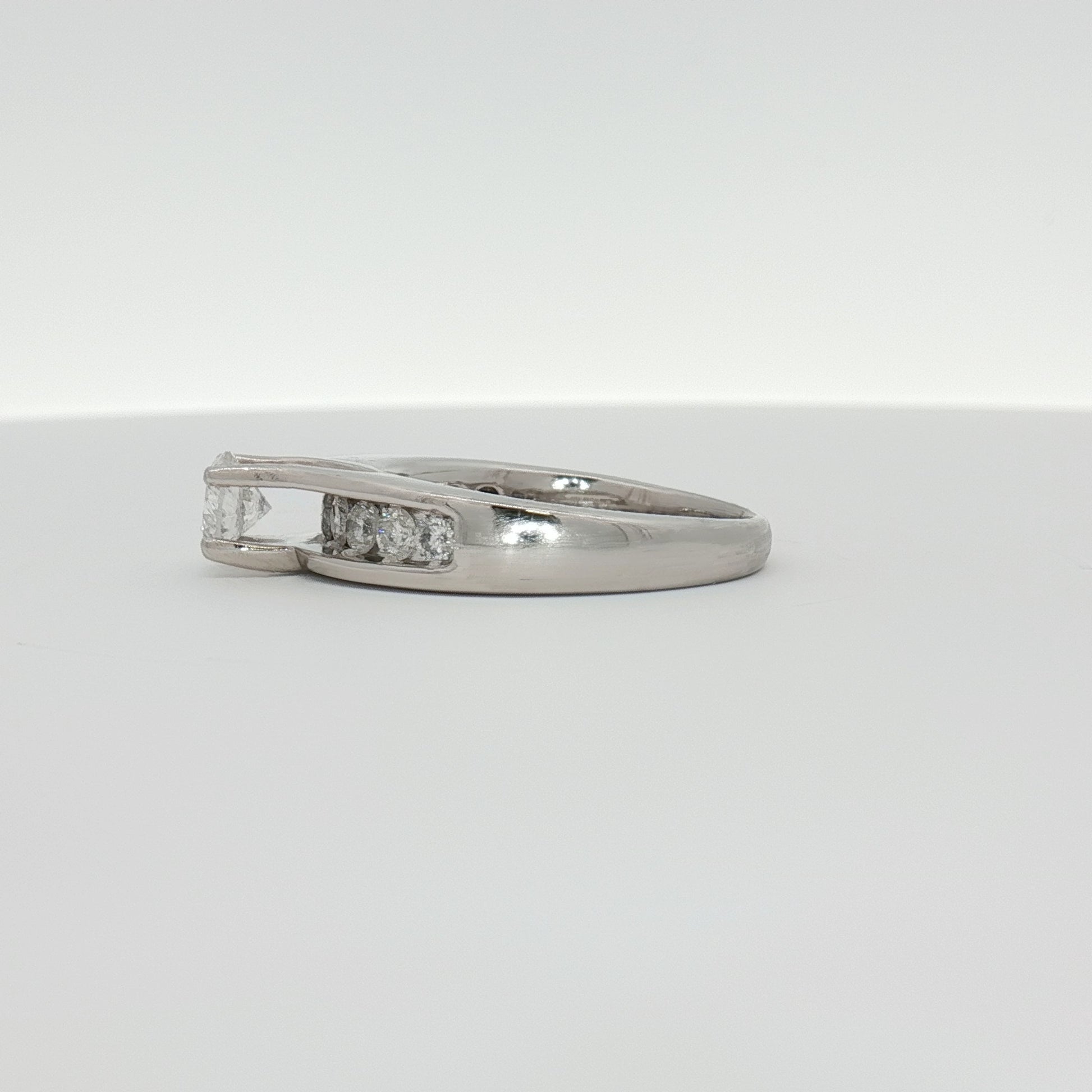 Elegant platinum diamond ring by Gold & Beyond featuring sparkling diamonds set in a sleek jewelry design.