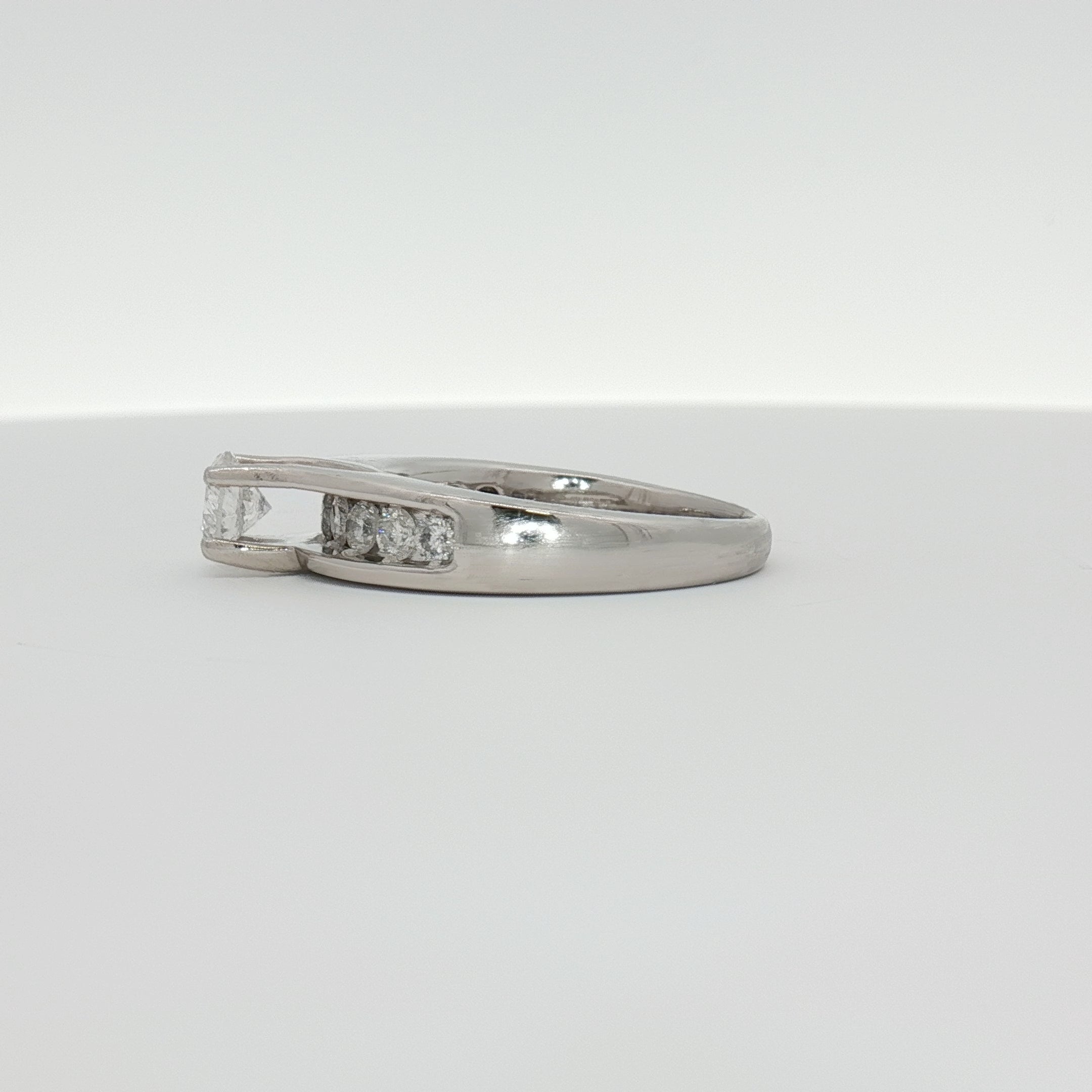 Elegant platinum diamond ring by Gold & Beyond featuring sparkling diamonds set in a sleek jewelry design.