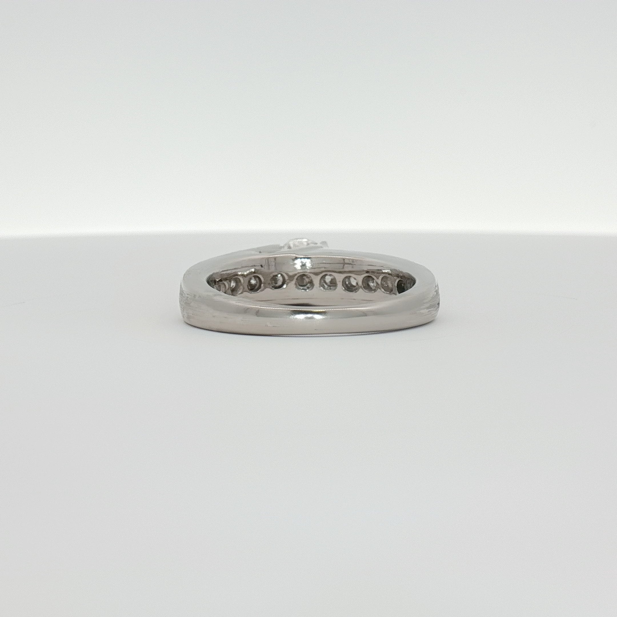 Platinum diamond ring from Gold & Beyond featuring a sparkling central diamond and sleek band design.