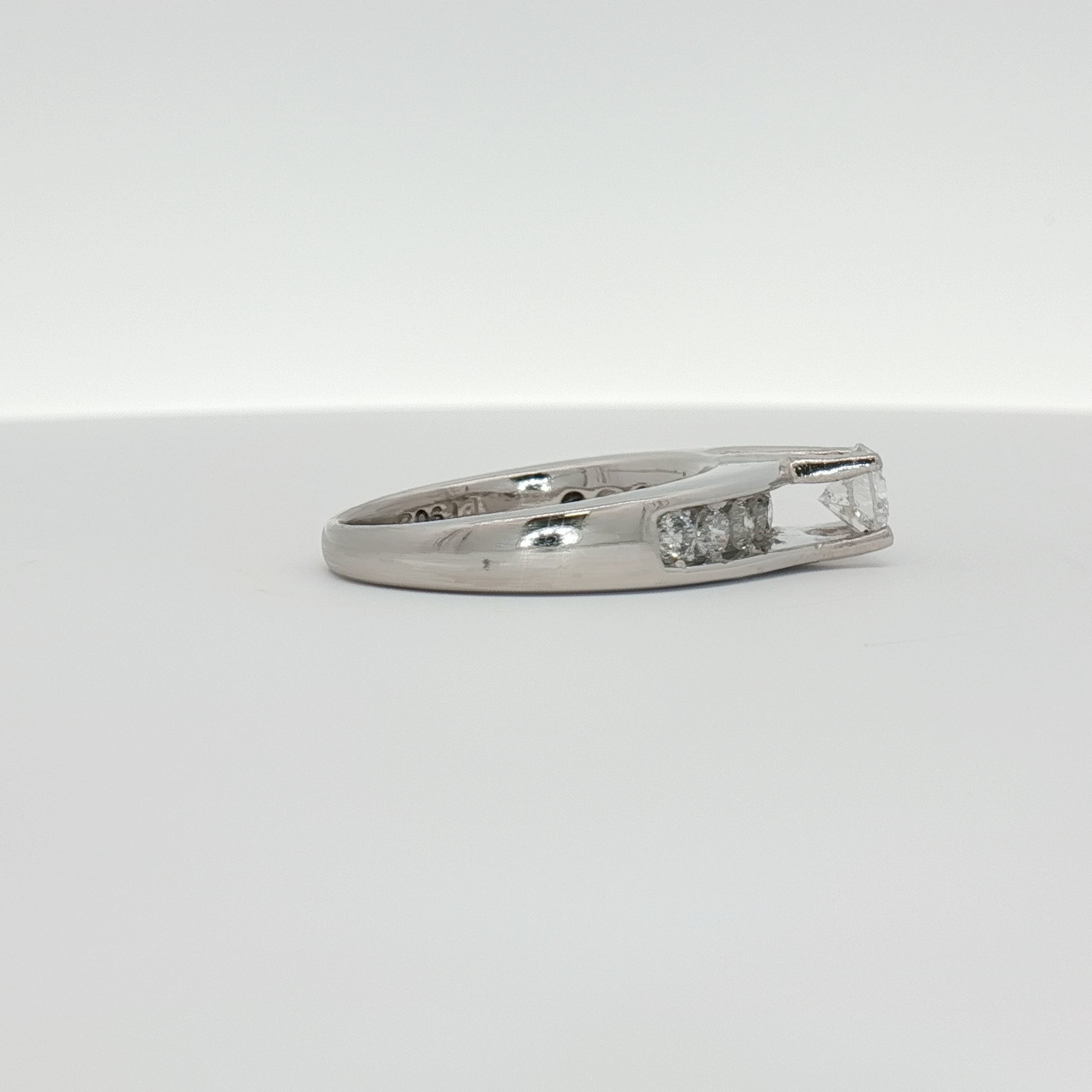 Platinum diamond ring by Gold & Beyond featuring a sparkling central diamond set in elegant jewelry design