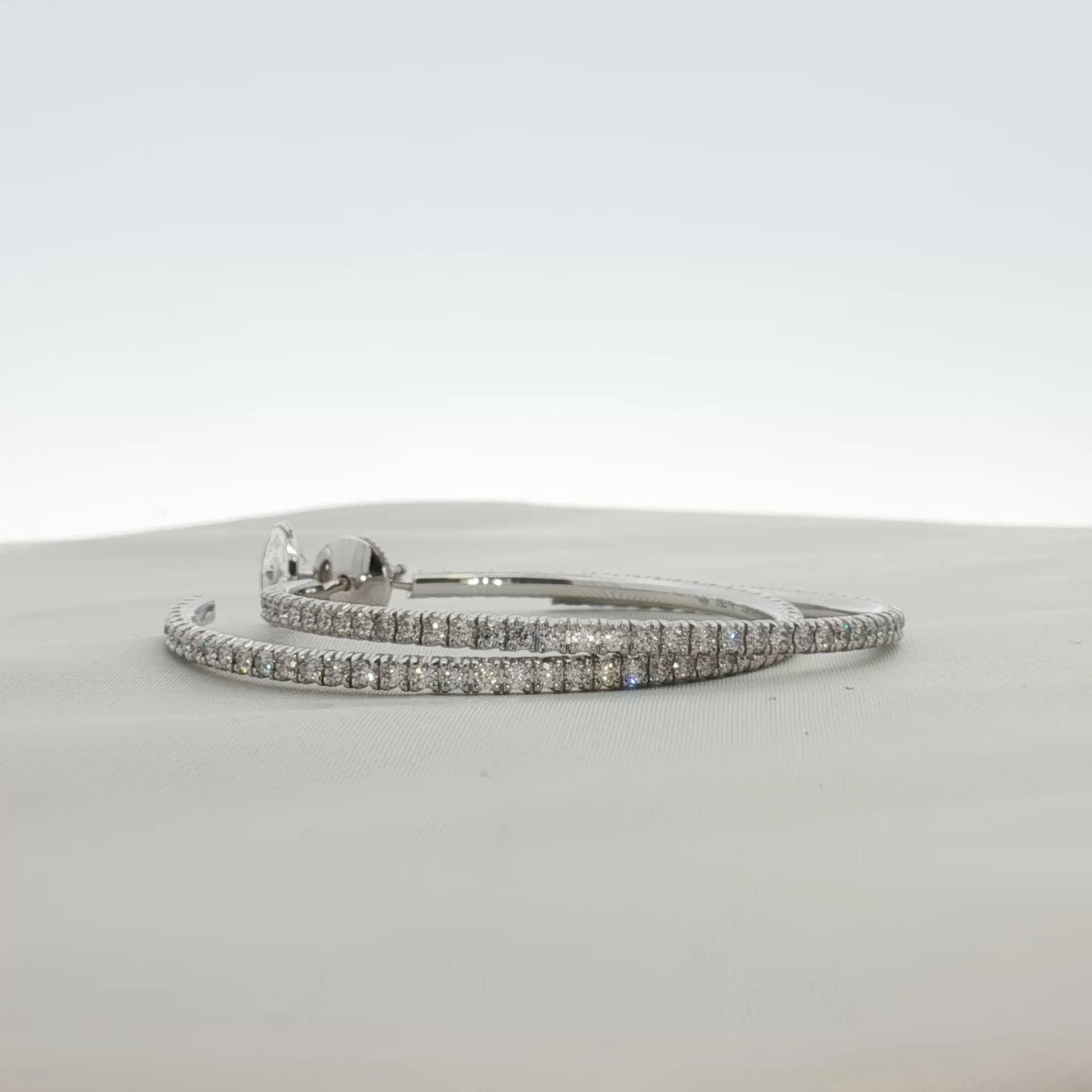 Cartier diamond hoop earrings featuring sparkling diamonds and gold hoops, elegant jewelry accessory.