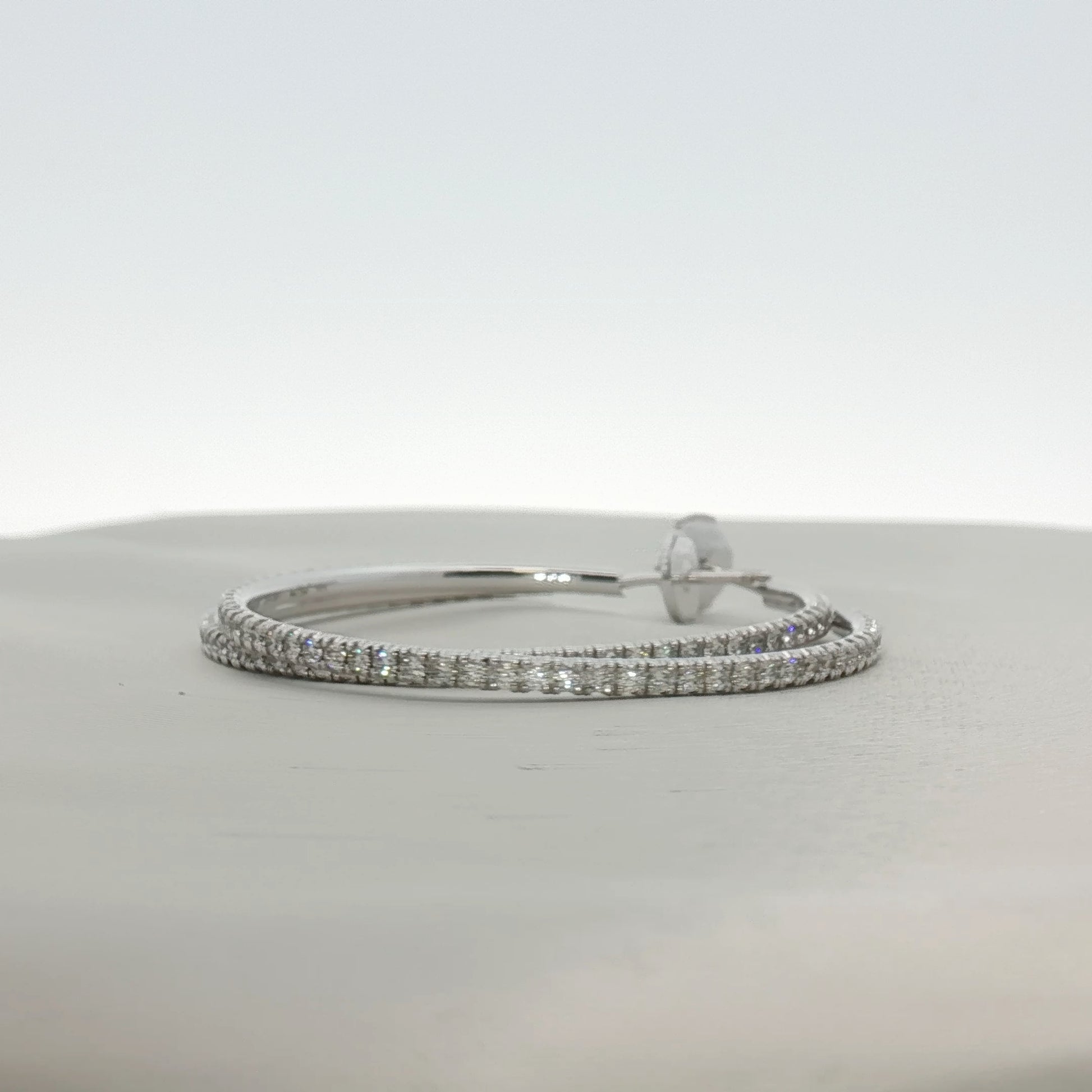 Cartier diamond hoop earrings in gold jewelry with sparkling diamond accents, elegant for special occasions.