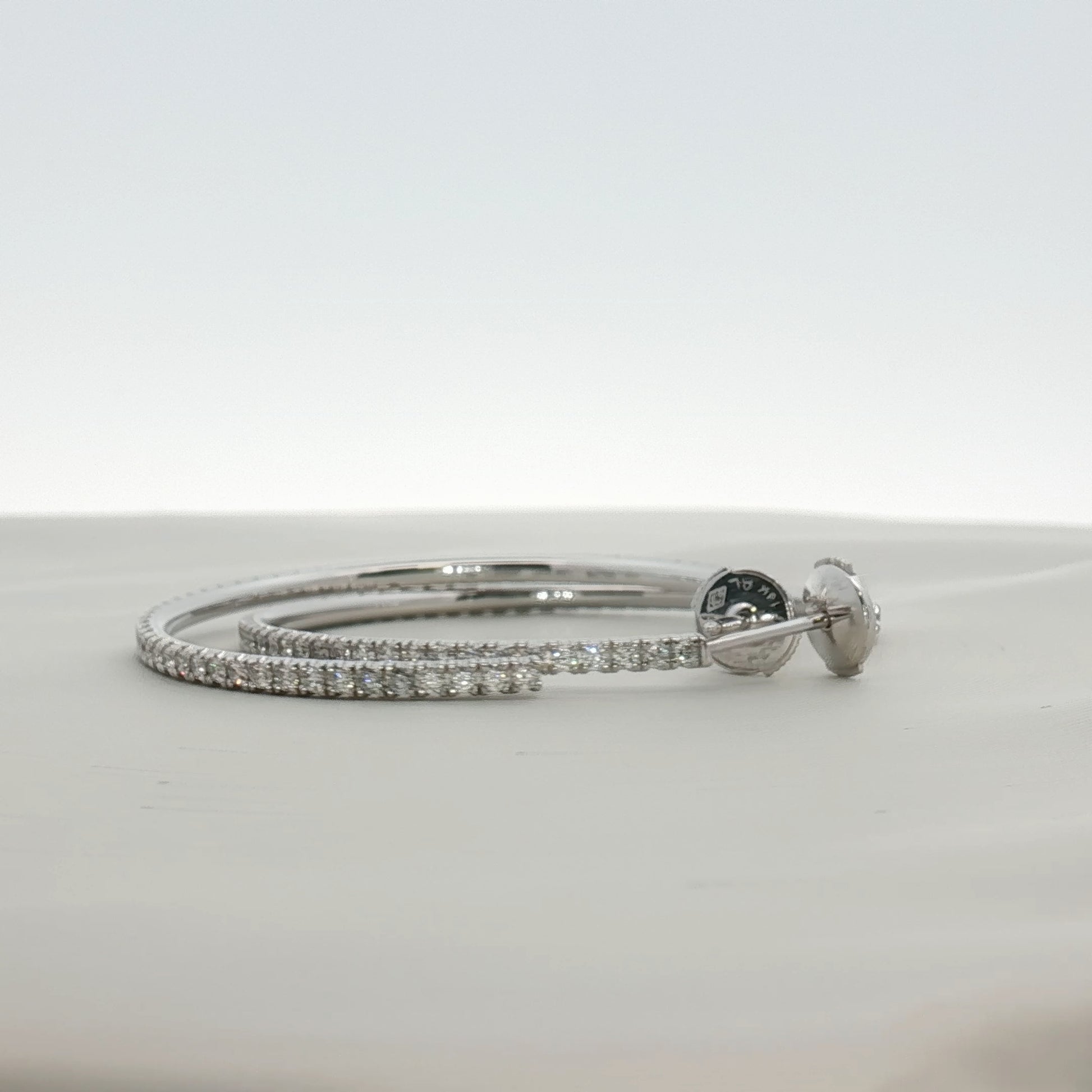 Cartier diamond hoop earrings in gold jewelry featuring sparkling diamonds and a classic hoop design.