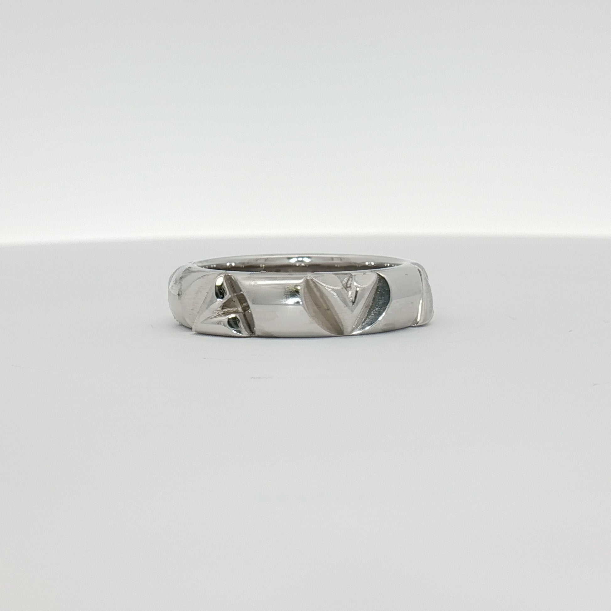 Louis Vuitton white gold Volt ring featuring a sleek, modern design with engraved logo, jewelry piece by Gold & Beyond