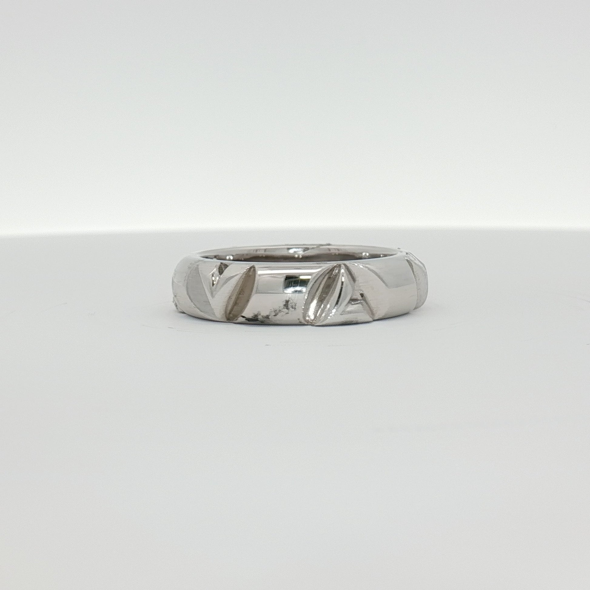 Louis Vuitton white gold Volt ring, a sleek jewelry piece with a polished finish, displayed on a neutral background.