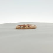 Gold & Beyond Cartier Love wedding band with diamonds, showcasing a sleek gold ring with sparkling diamond accents.