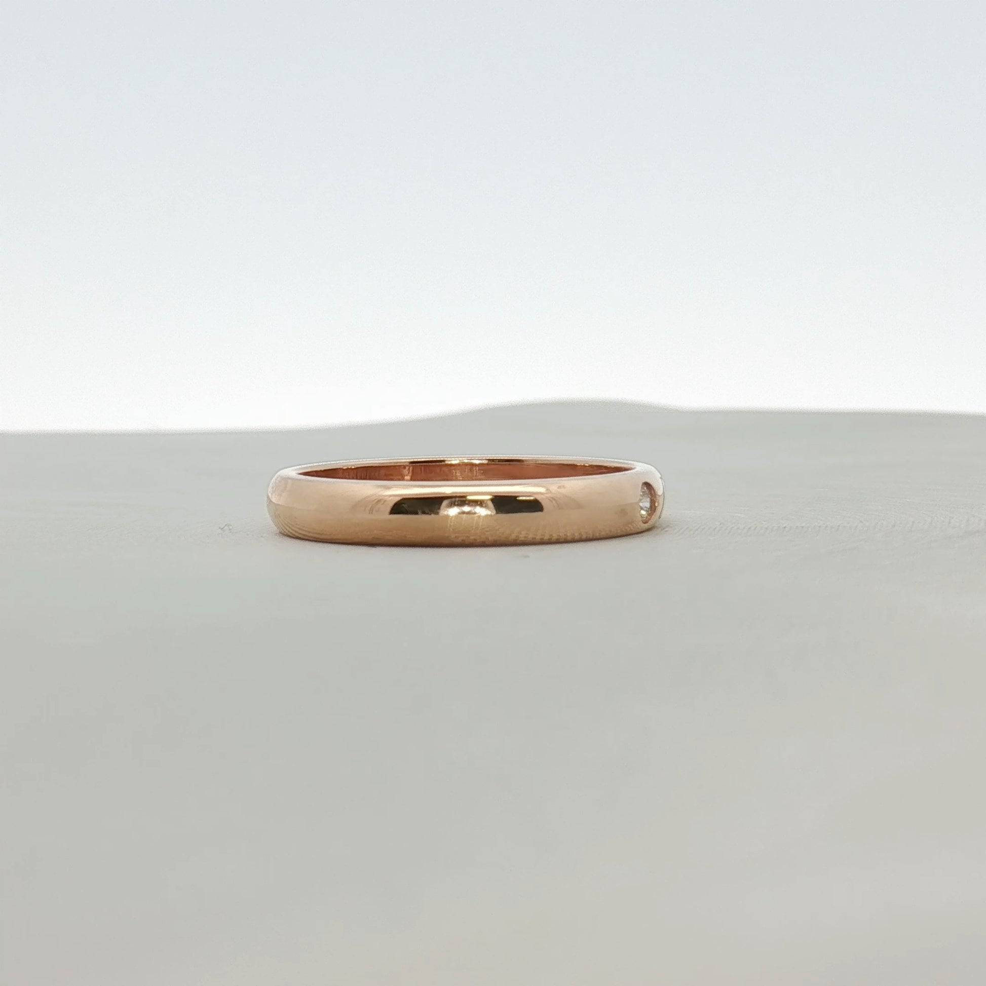 Cartier Love Wedding Band with diamond, gold jewelry featuring a sleek design and embedded sparkling diamond accents.