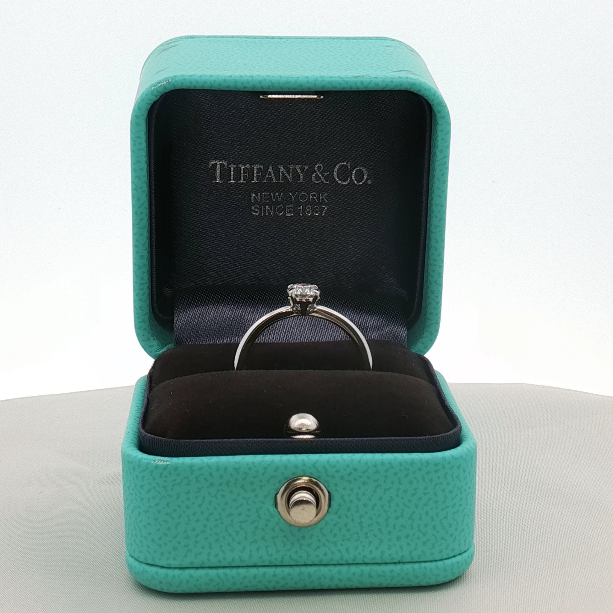 Gold & Beyond Tiffany & Co. True Engagement Ring featuring a sparkling diamond solitaire in elegant jewelry setting.