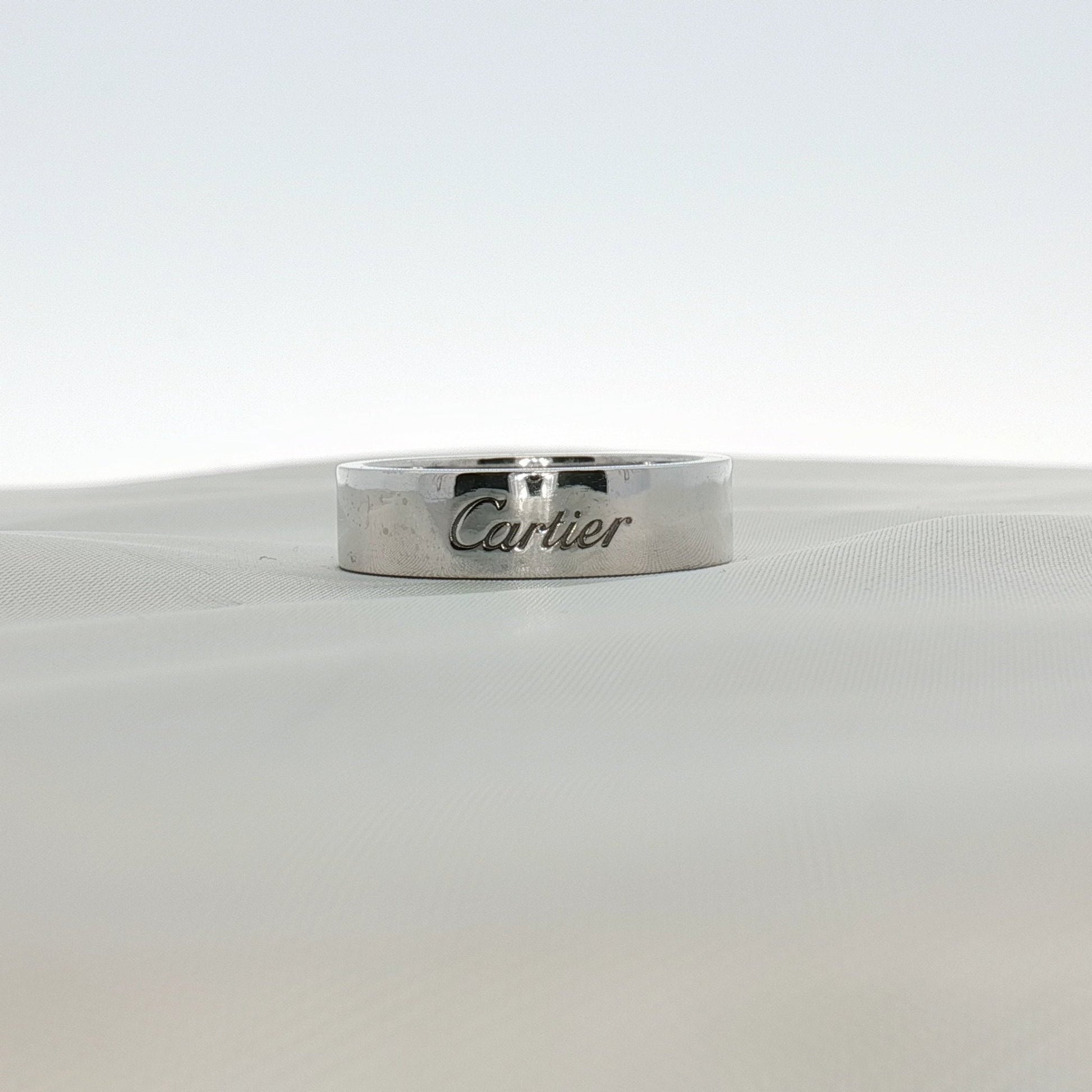 Cartier platinum wedding band ring with a sleek, polished finish, designed for elegant jewelry and wedding accessories.
