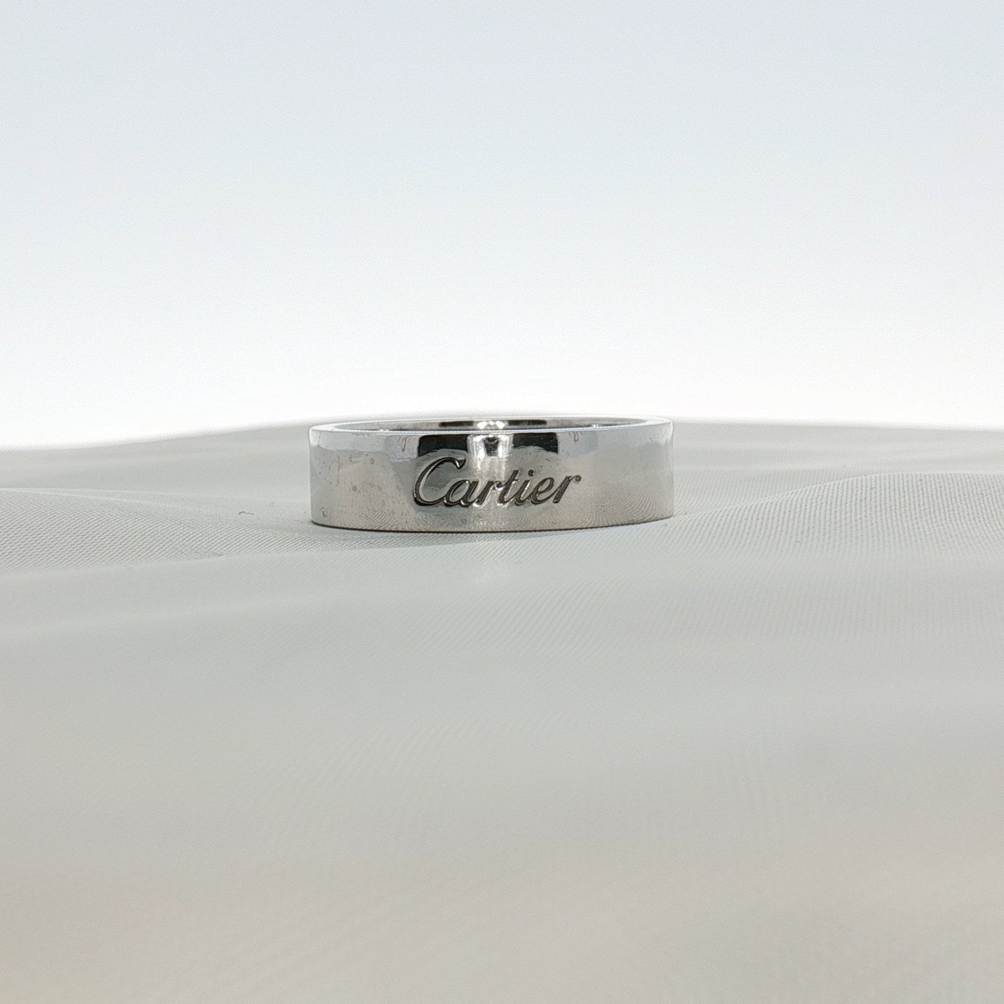 Cartier platinum wedding band ring with a sleek, polished finish, designed for elegant jewelry and wedding accessories.
