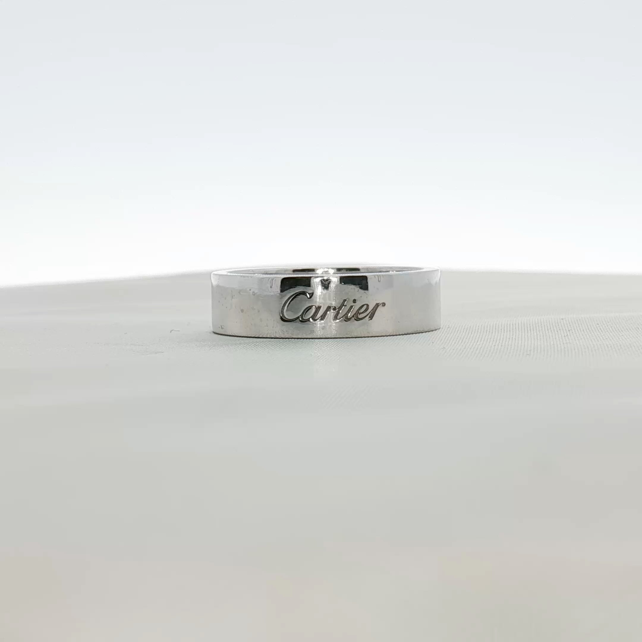 Cartier platinum wedding band ring with a sleek, polished finish, designed for elegant wedding jewelry.