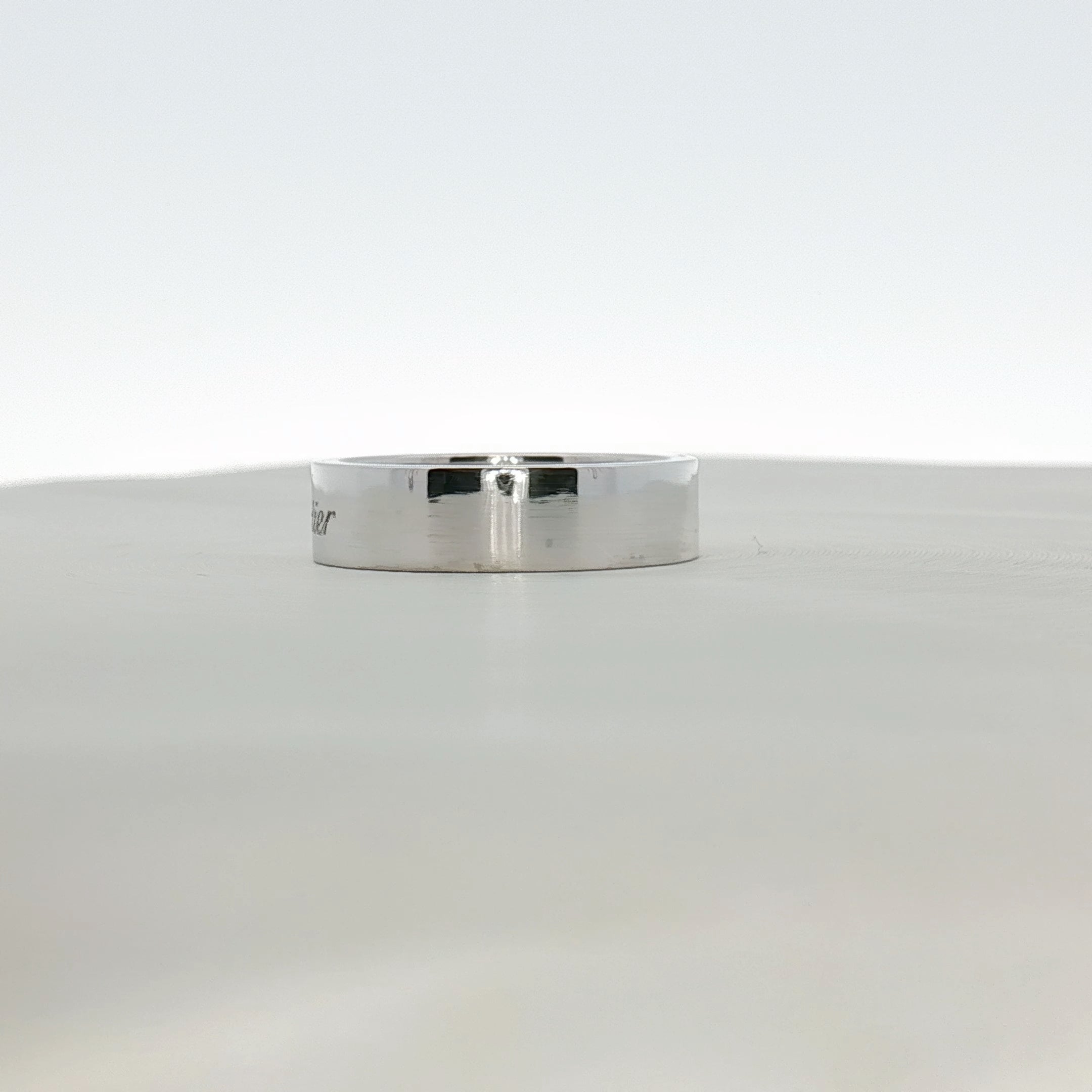 Cartier platinum wedding band ring, sleek and polished jewelry piece with a smooth finish and classic design.